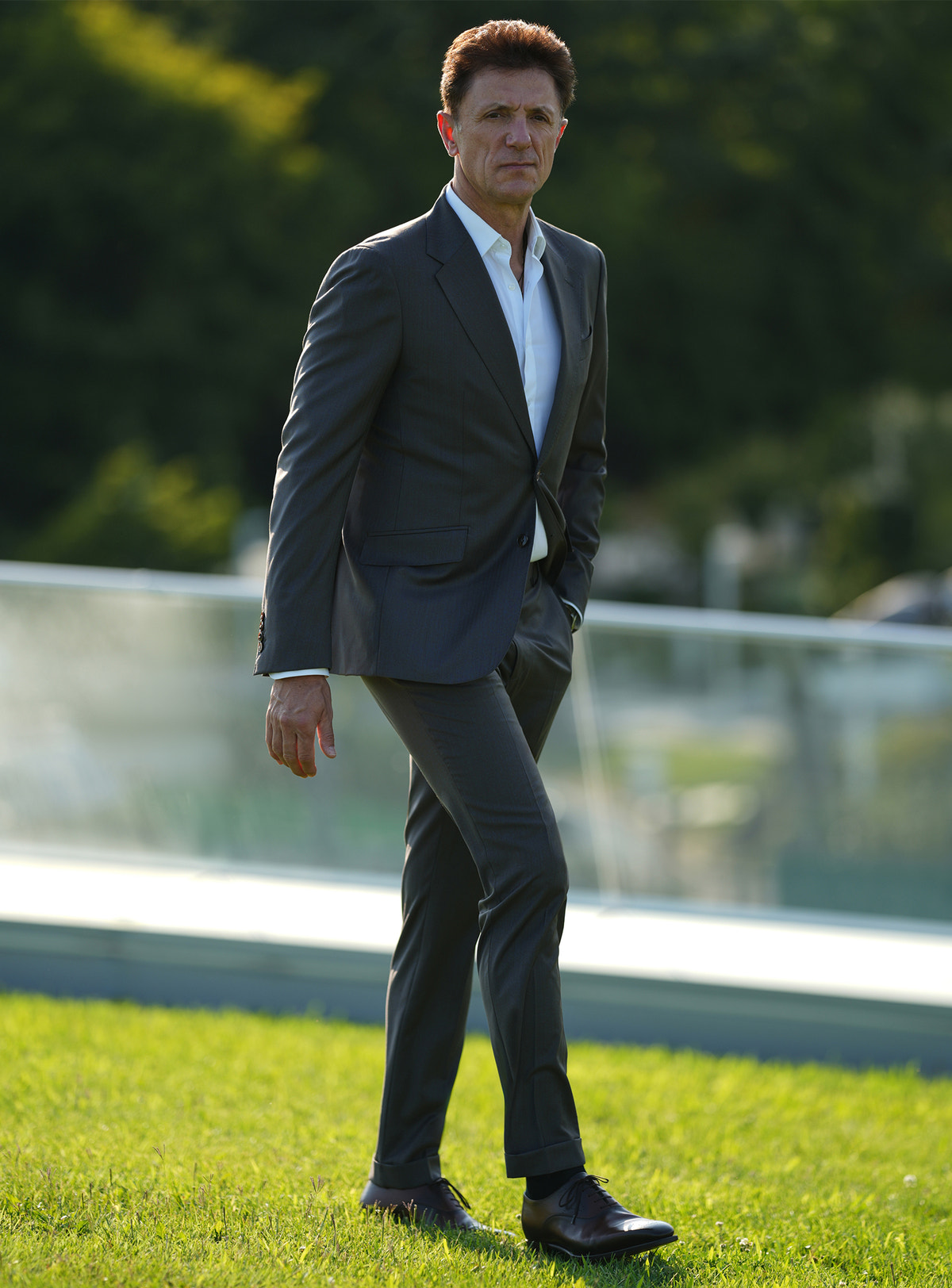 Dark-toned Consiglieri suit worn outdoors with a white shirt