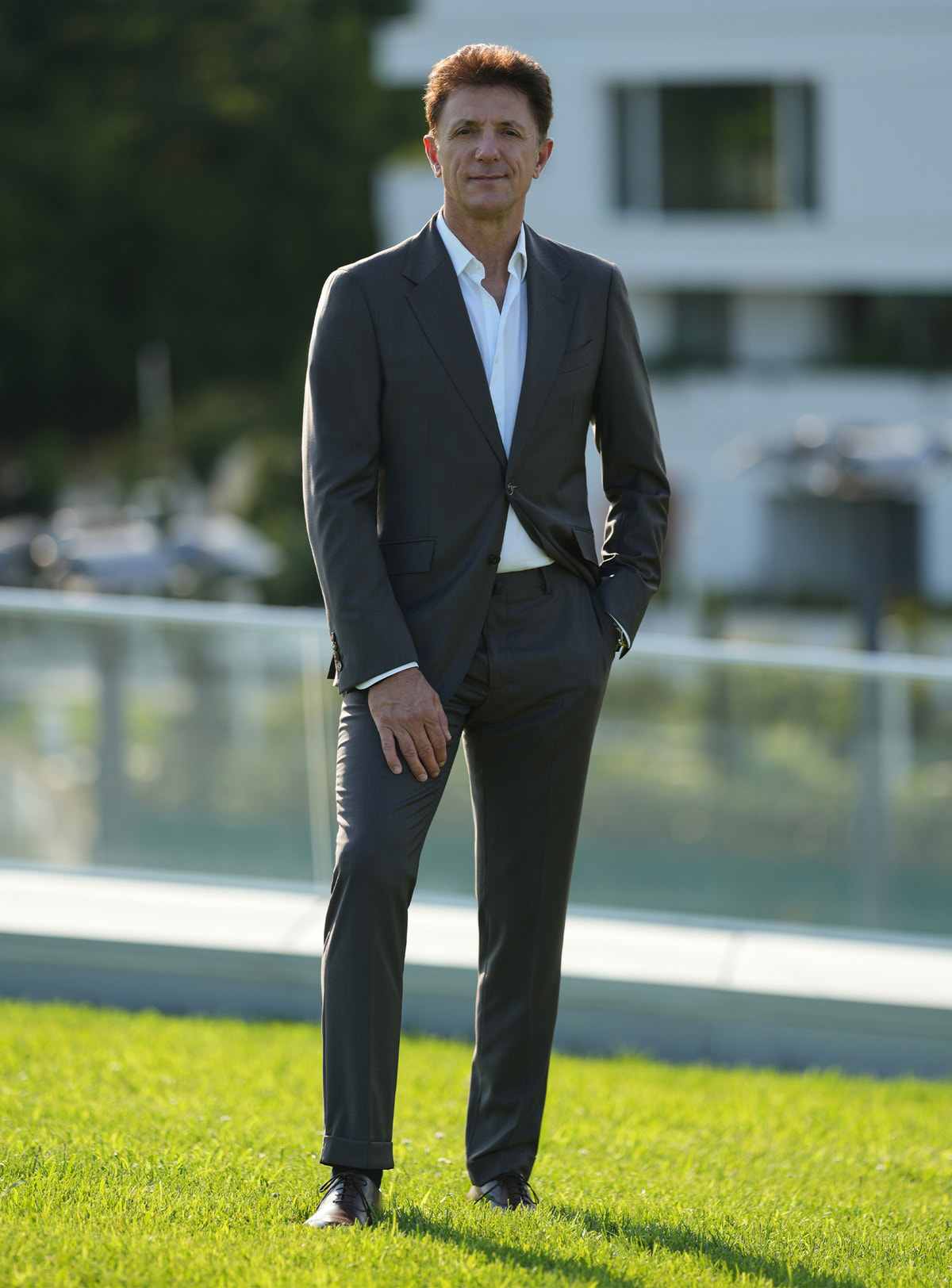 Dark-toned Consiglieri suit worn outdoors with a white shirt