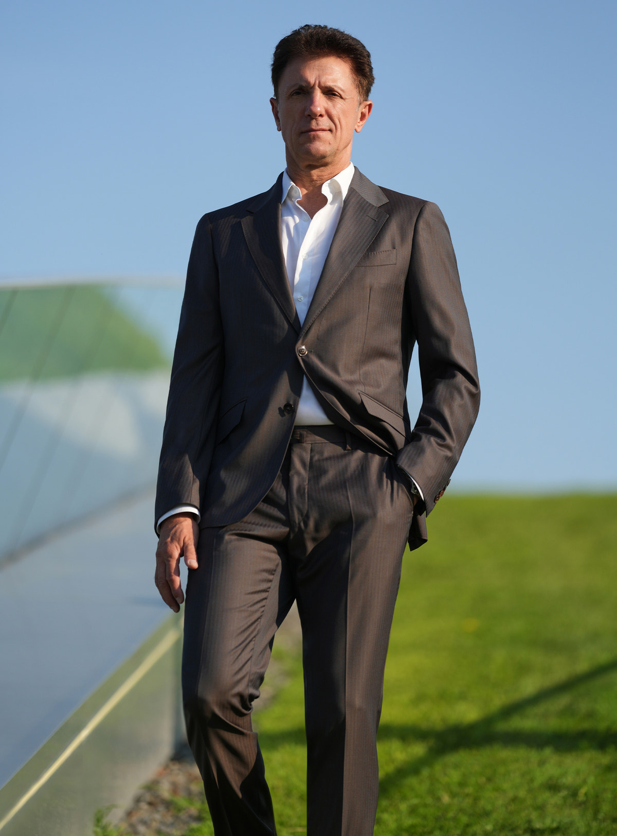 Dark-toned Consiglieri suit worn outdoors with a white shirt