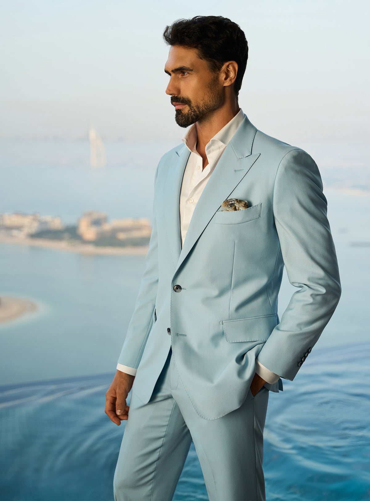 Consiglieri Visionary Artistry: light blue suit with an open-collar white shirt
