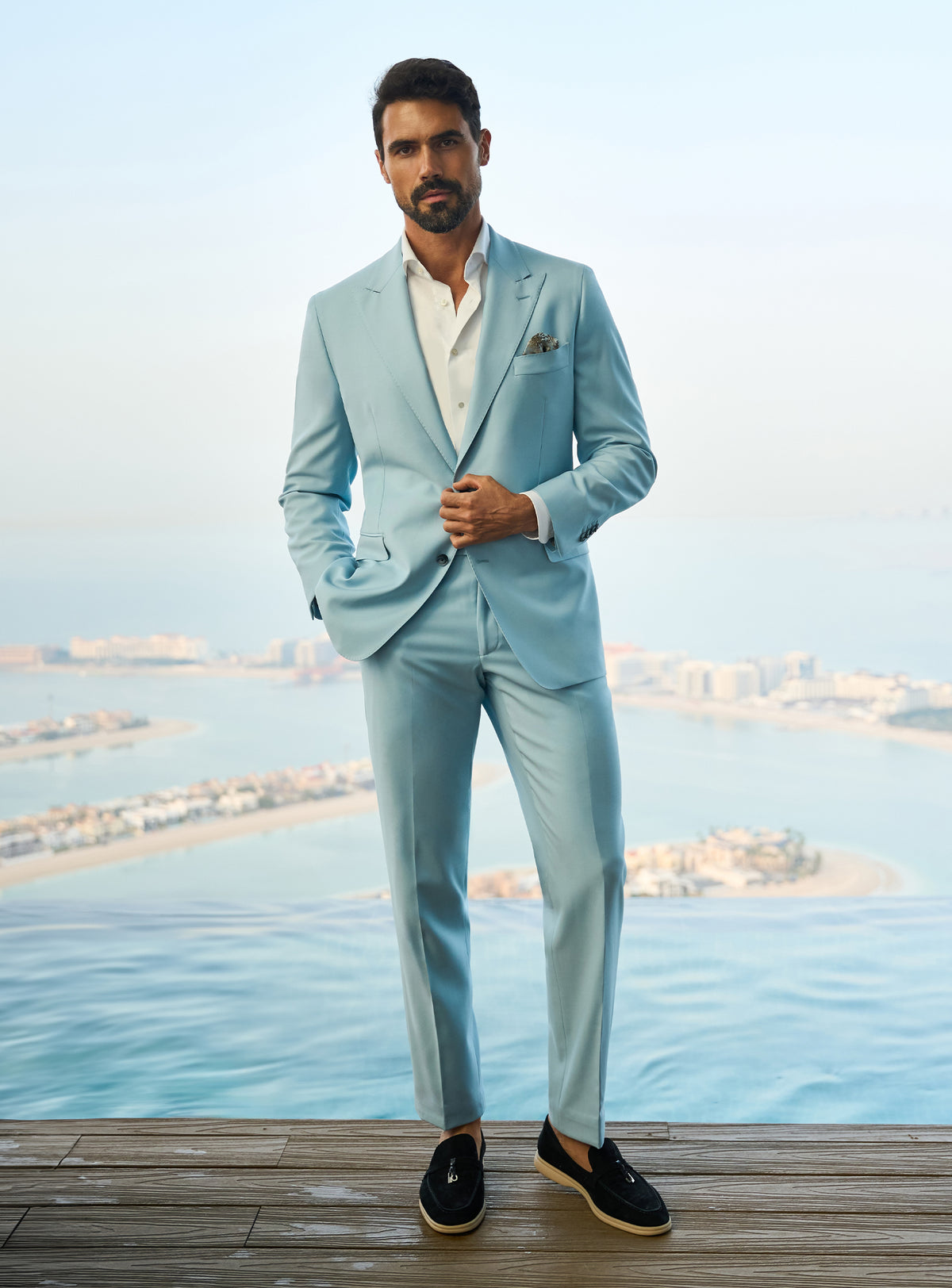 Consiglieri Visionary Artistry: light blue suit with an open-collar white shirt