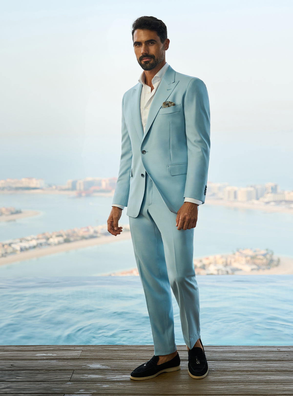Consiglieri Visionary Artistry: light blue suit with an open-collar white shirt