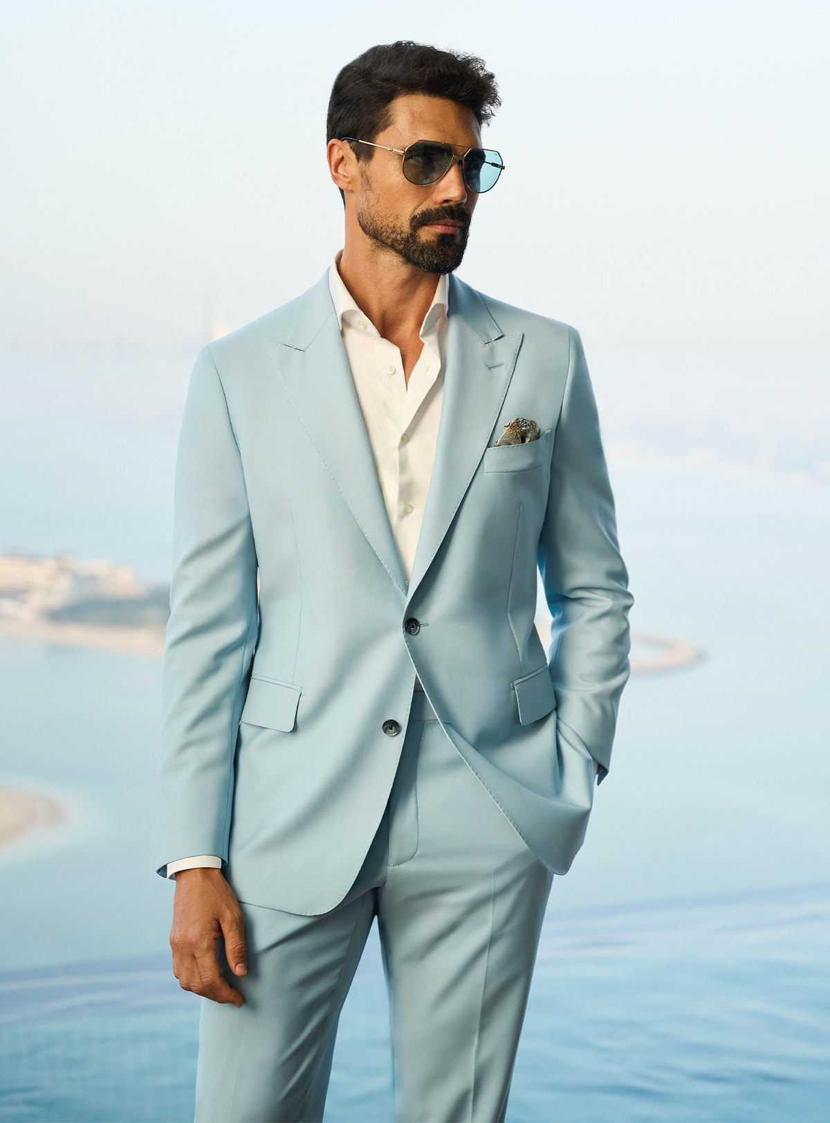 Consiglieri Visionary Artistry: light blue suit with an open-collar white shirt