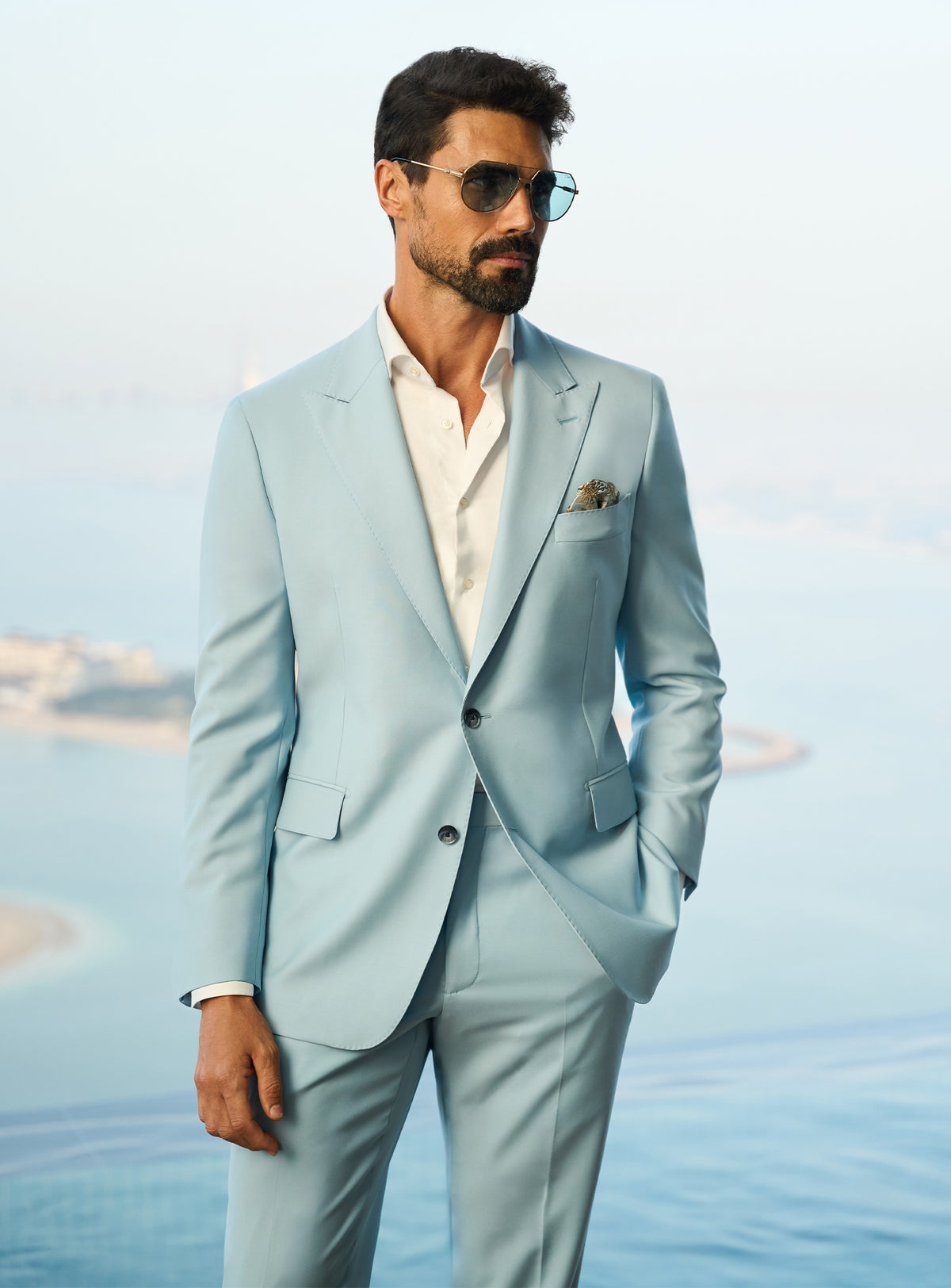 Consiglieri Visionary Artistry: light blue suit with an open-collar white shirt