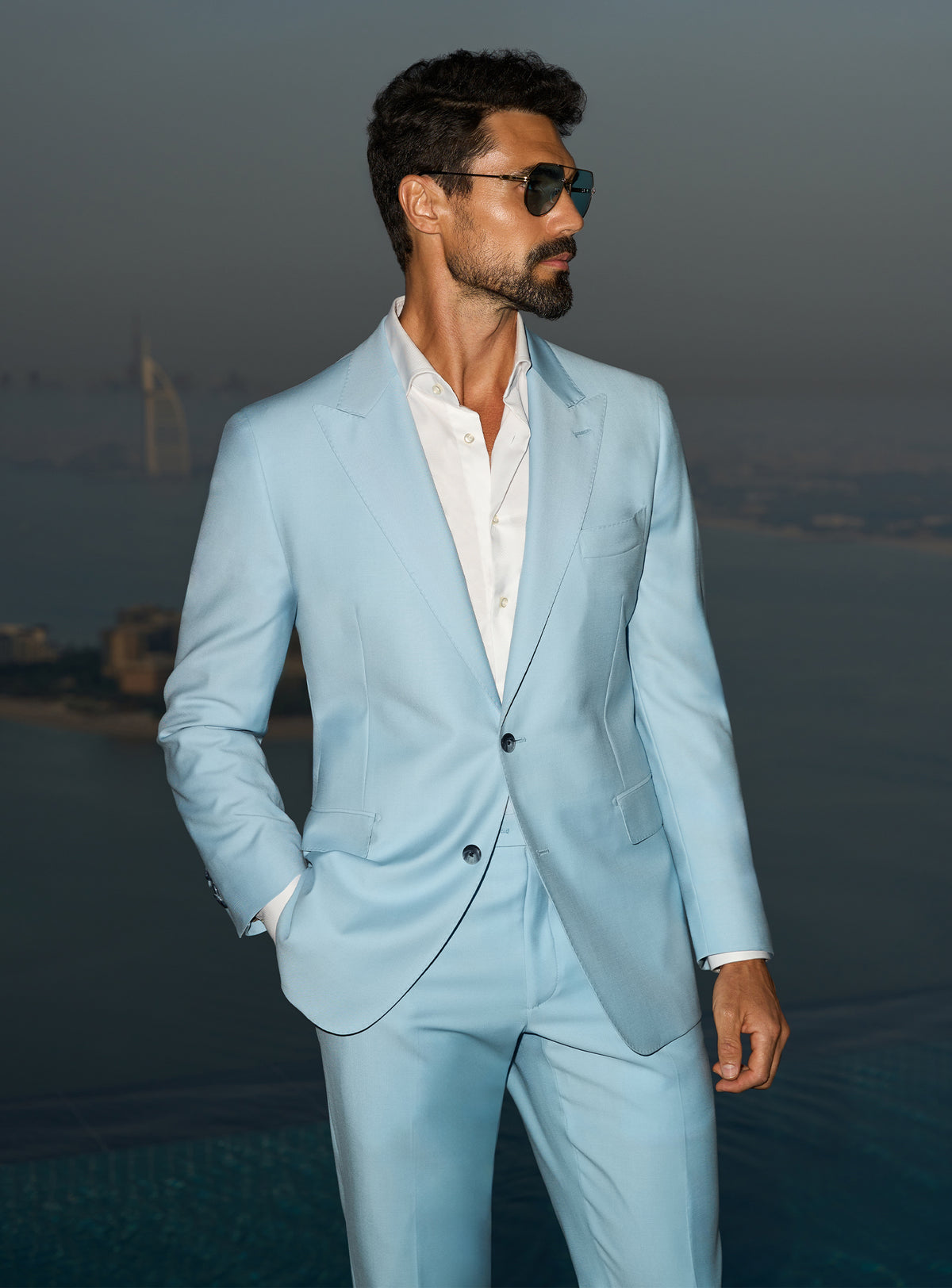 Consiglieri Visionary Artistry: light blue suit with an open-collar white shirt