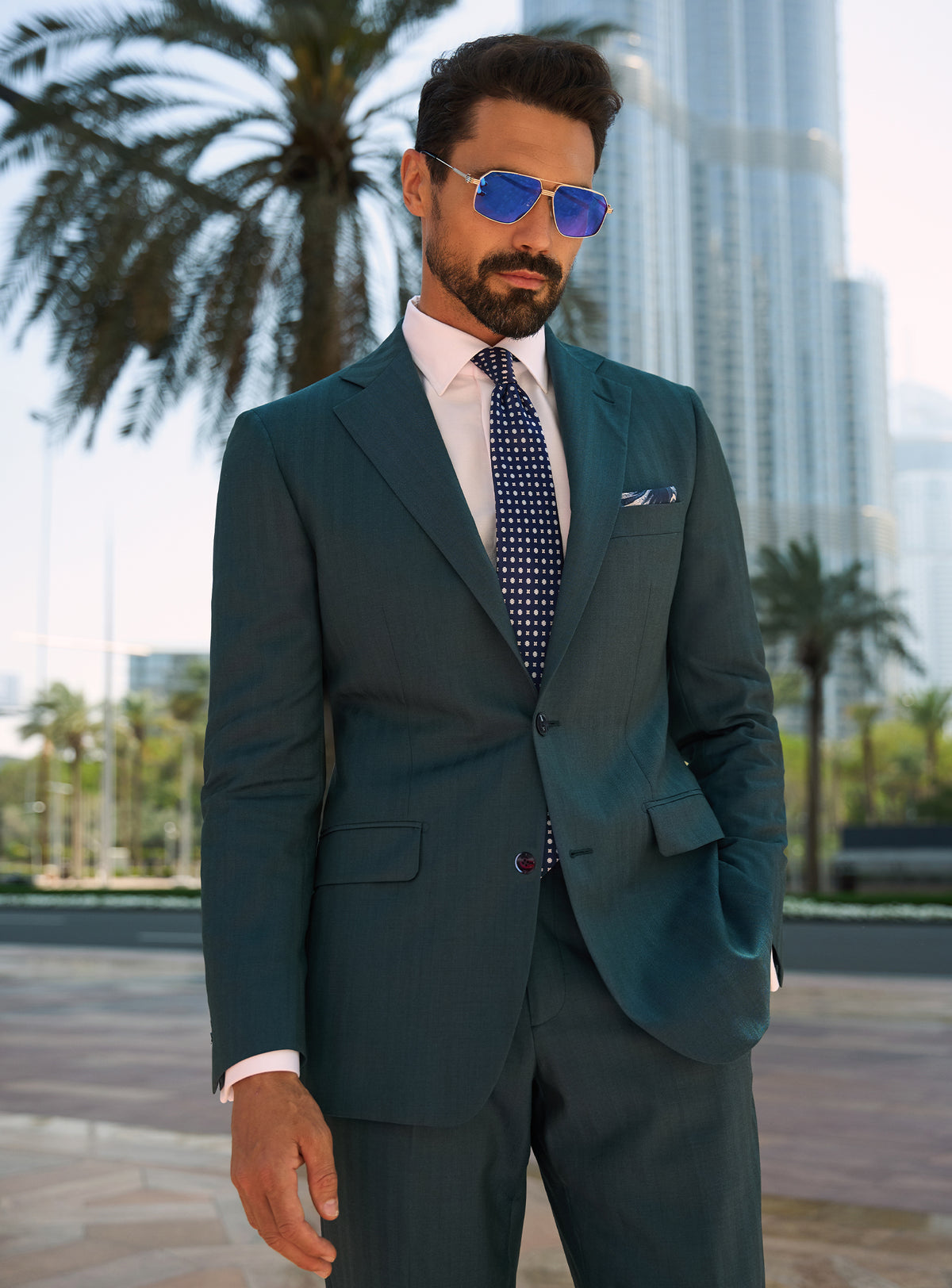 Consiglieri Royal Dignity: teal suit with a white shirt and navy tie