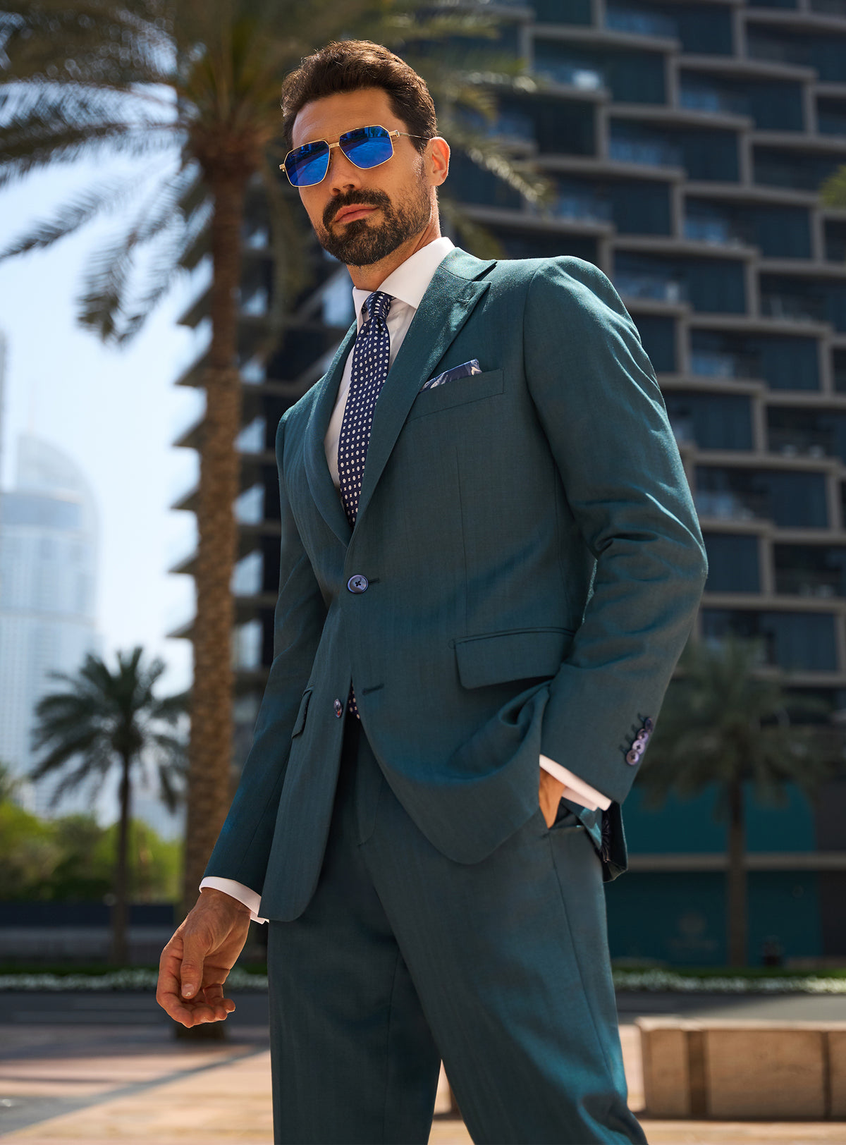 Consiglieri Royal Dignity: teal suit with a white shirt and navy tie