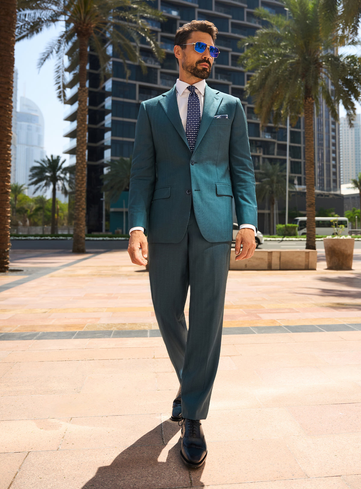 Consiglieri Royal Dignity: teal suit with a white shirt and navy tie