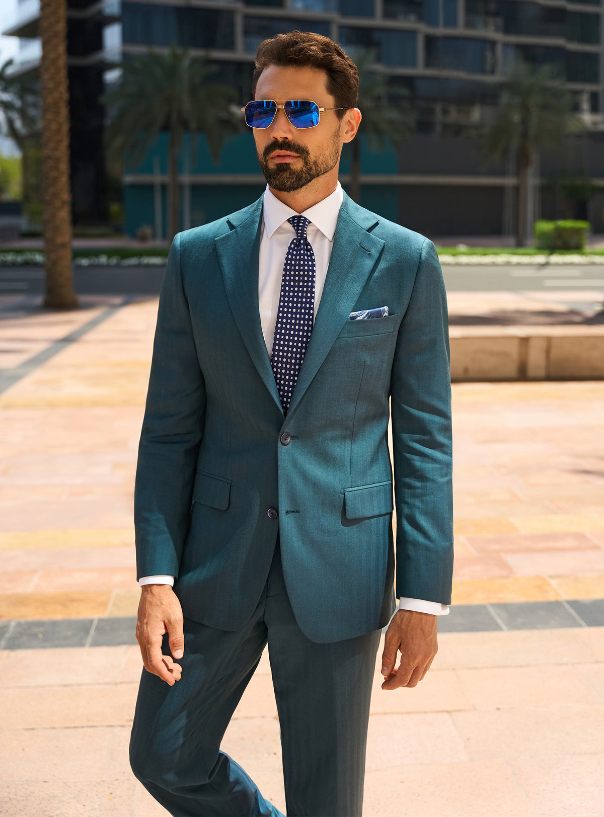 Consiglieri Royal Dignity: teal suit with a white shirt and navy tie