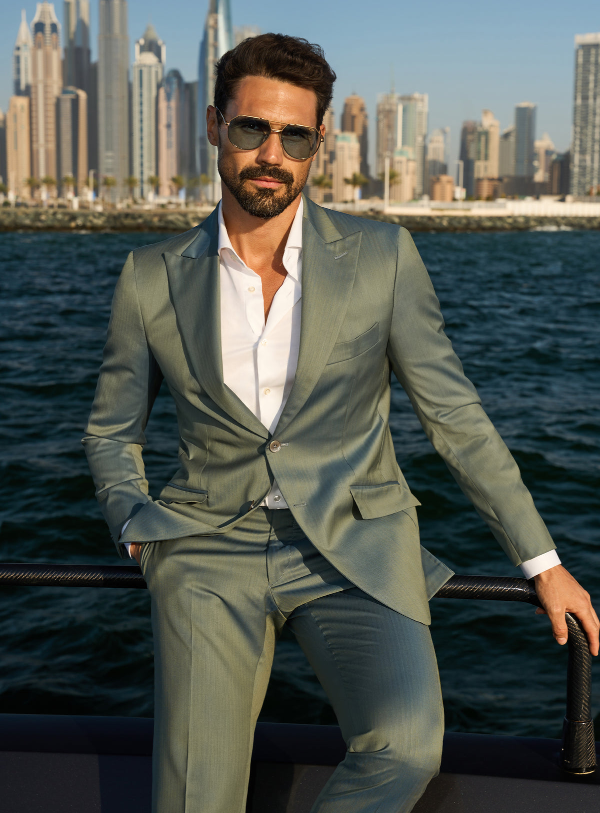 Consiglieri Solaris Essence: sage green suit with a white shirt, worn on a yacht deck