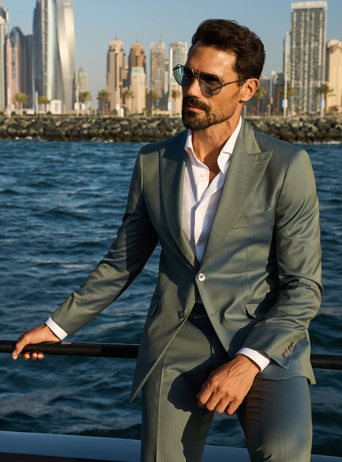 Consiglieri Solaris Essence: sage green suit with a white shirt, worn on a yacht deck