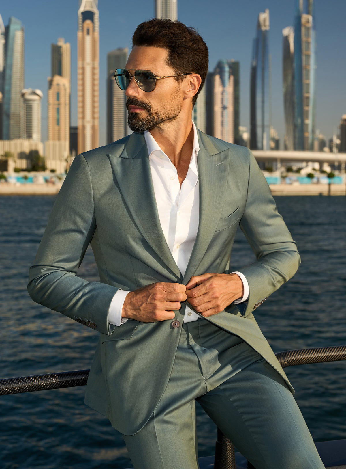 Consiglieri Solaris Essence: sage green suit with a white shirt, worn on a yacht deck