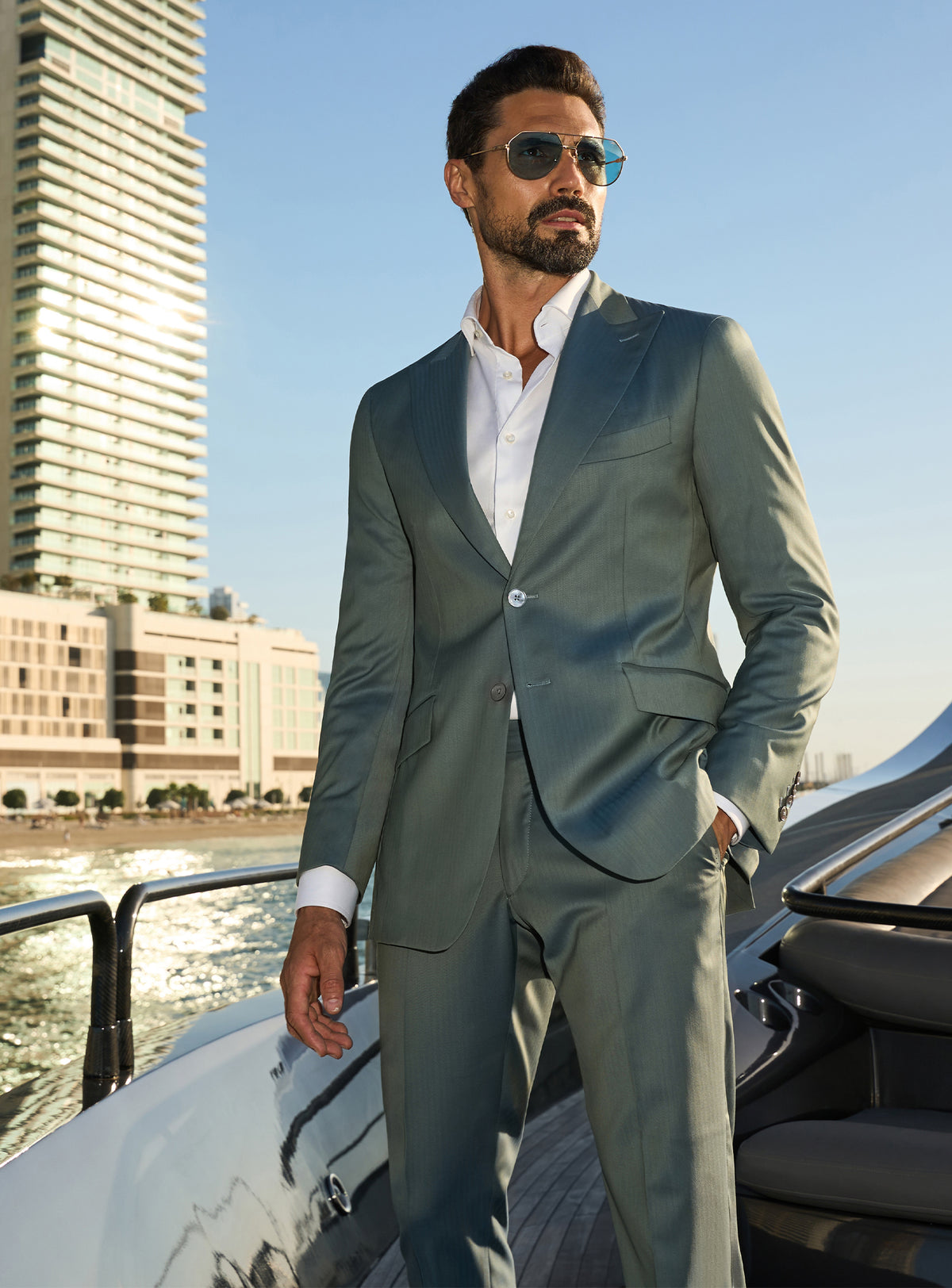 Consiglieri Solaris Essence: sage green suit with a white shirt, worn on a yacht deck