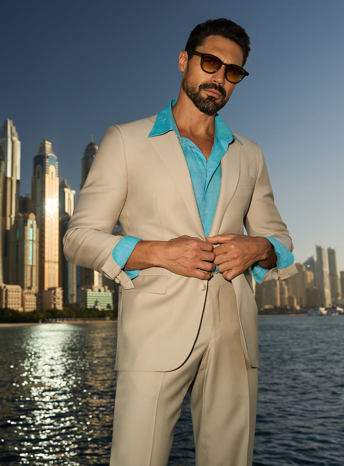 Consiglieri Splendor Radiance: cream suit with a turquoise shirt, worn on a yacht deck