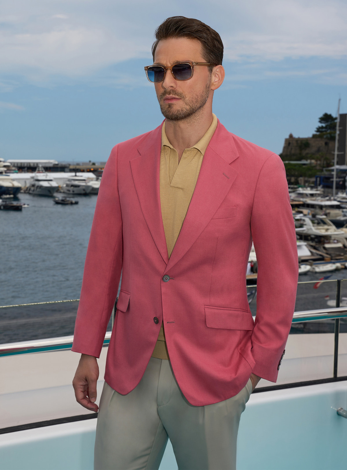 Pink Consiglieri jacket with an ochre polo shirt and light trousers