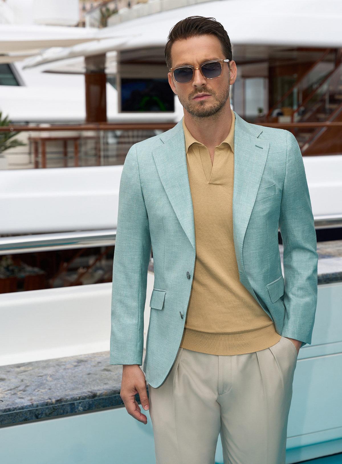 Mint green Consiglieri jacket with an ochre polo shirt and light beige trousers