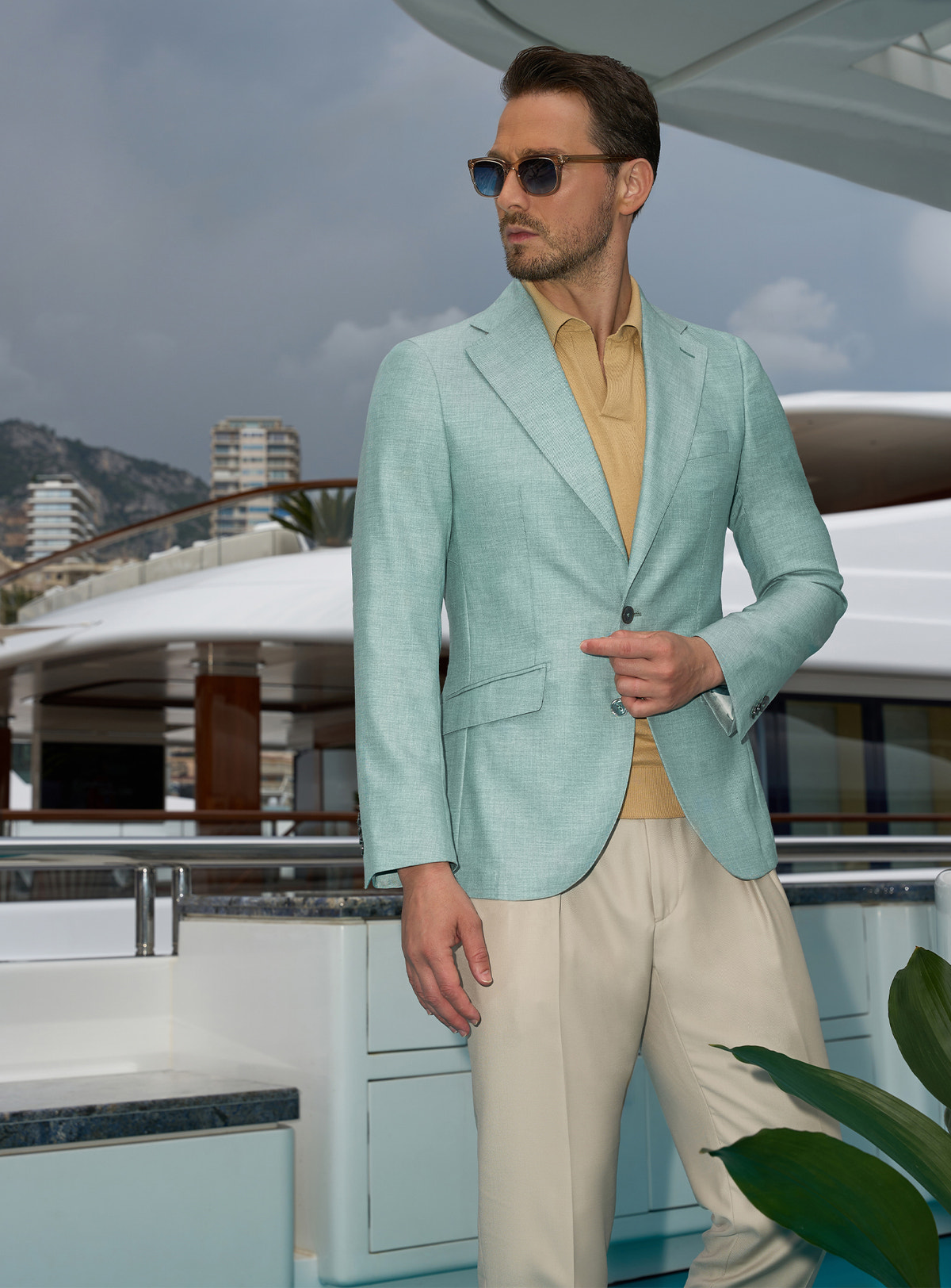 Mint green Consiglieri jacket with an ochre polo shirt and light beige trousers