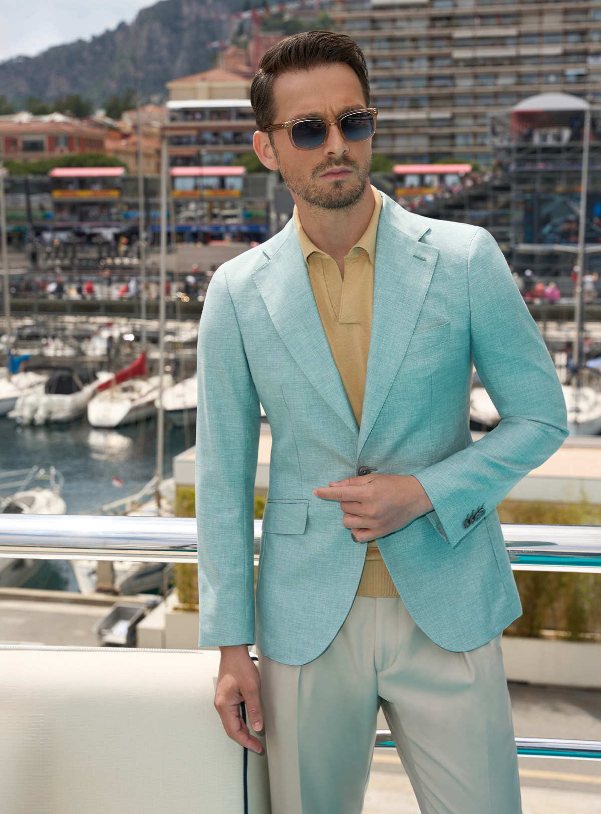 Mint green Consiglieri jacket with an ochre polo shirt and light beige trousers