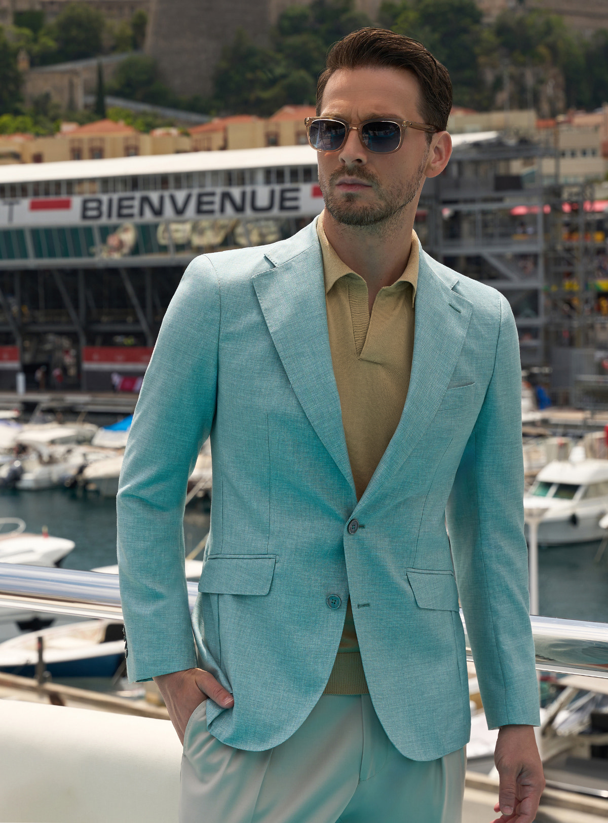 Mint green Consiglieri jacket with an ochre polo shirt and light beige trousers
