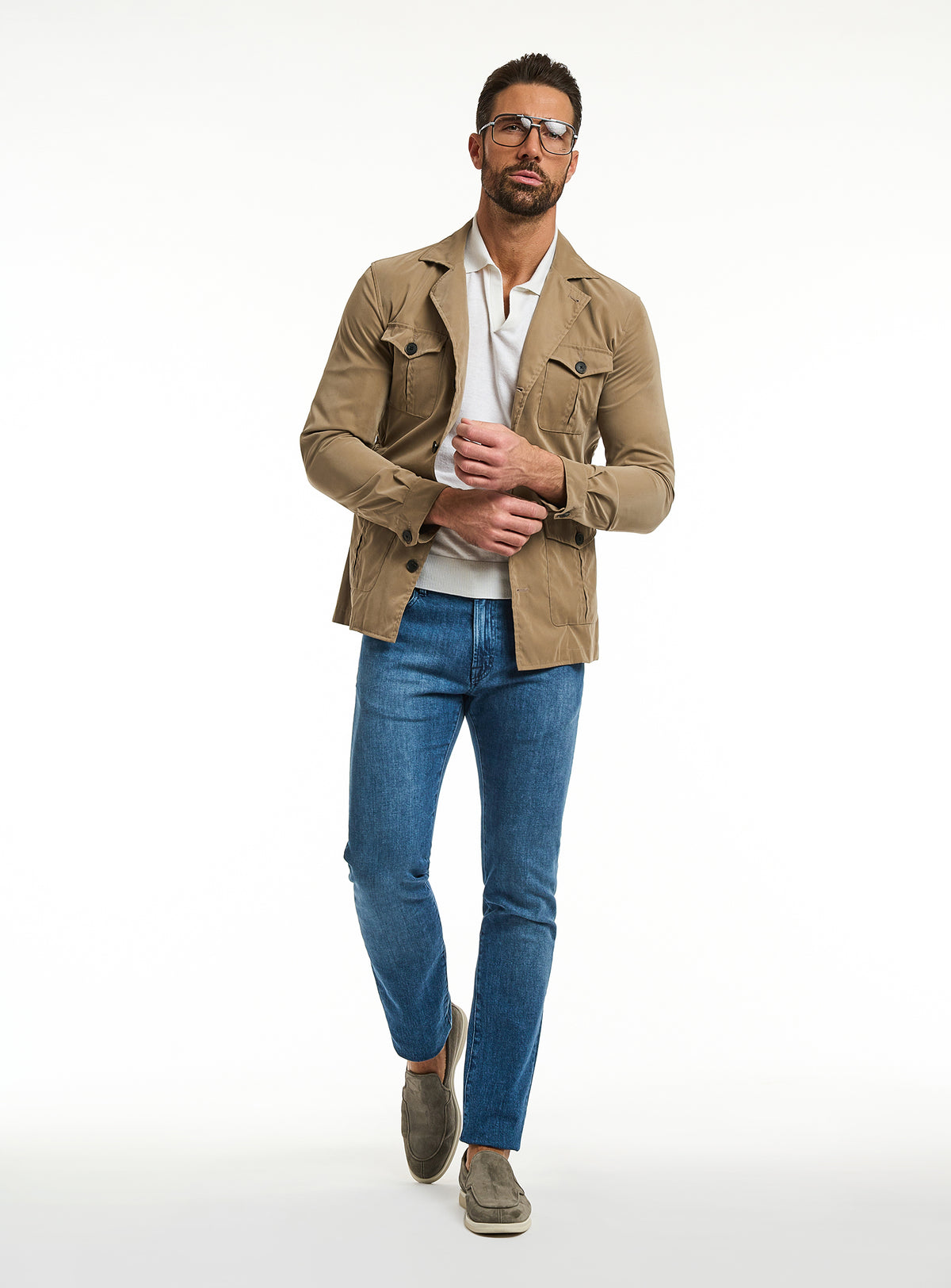 Consiglieri: blue jeans with a camel jacket and ivory polo