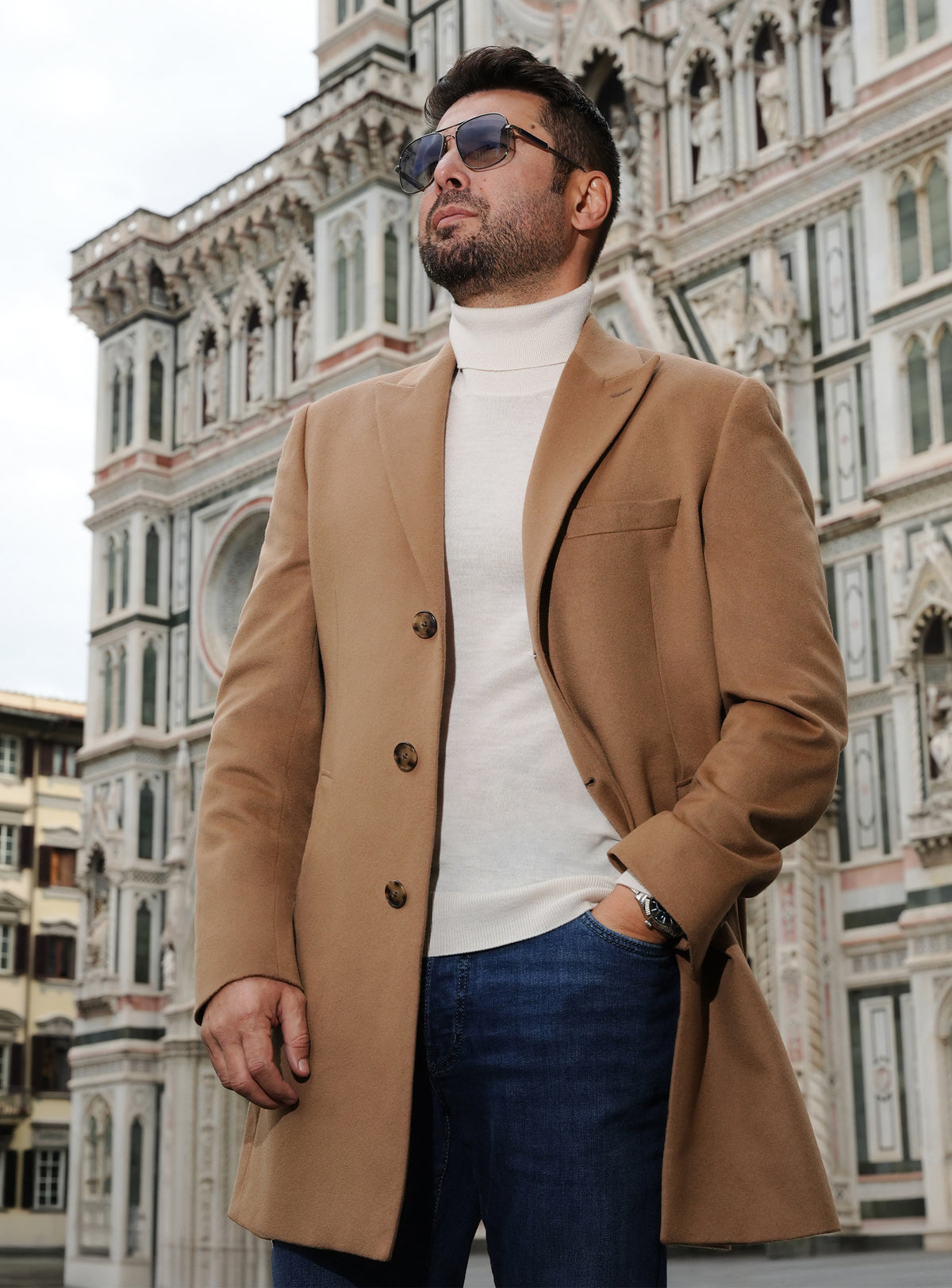 Camel Consiglieri overcoat with notch lapels, a white turtleneck and jeans
