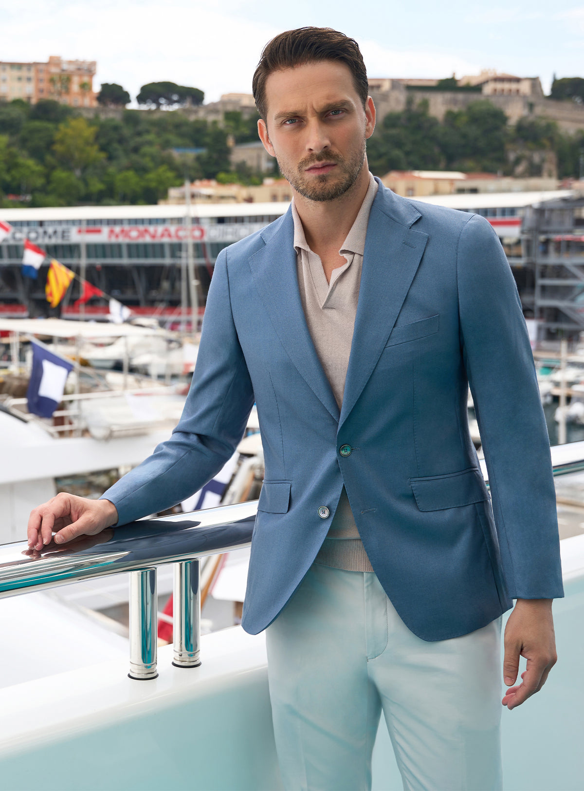 Blue Consiglieri jacket worn with a beige polo shirt and light trousers