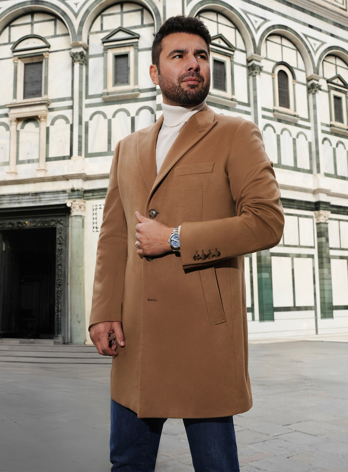 Camel Consiglieri overcoat with notch lapels, a white turtleneck and jeans