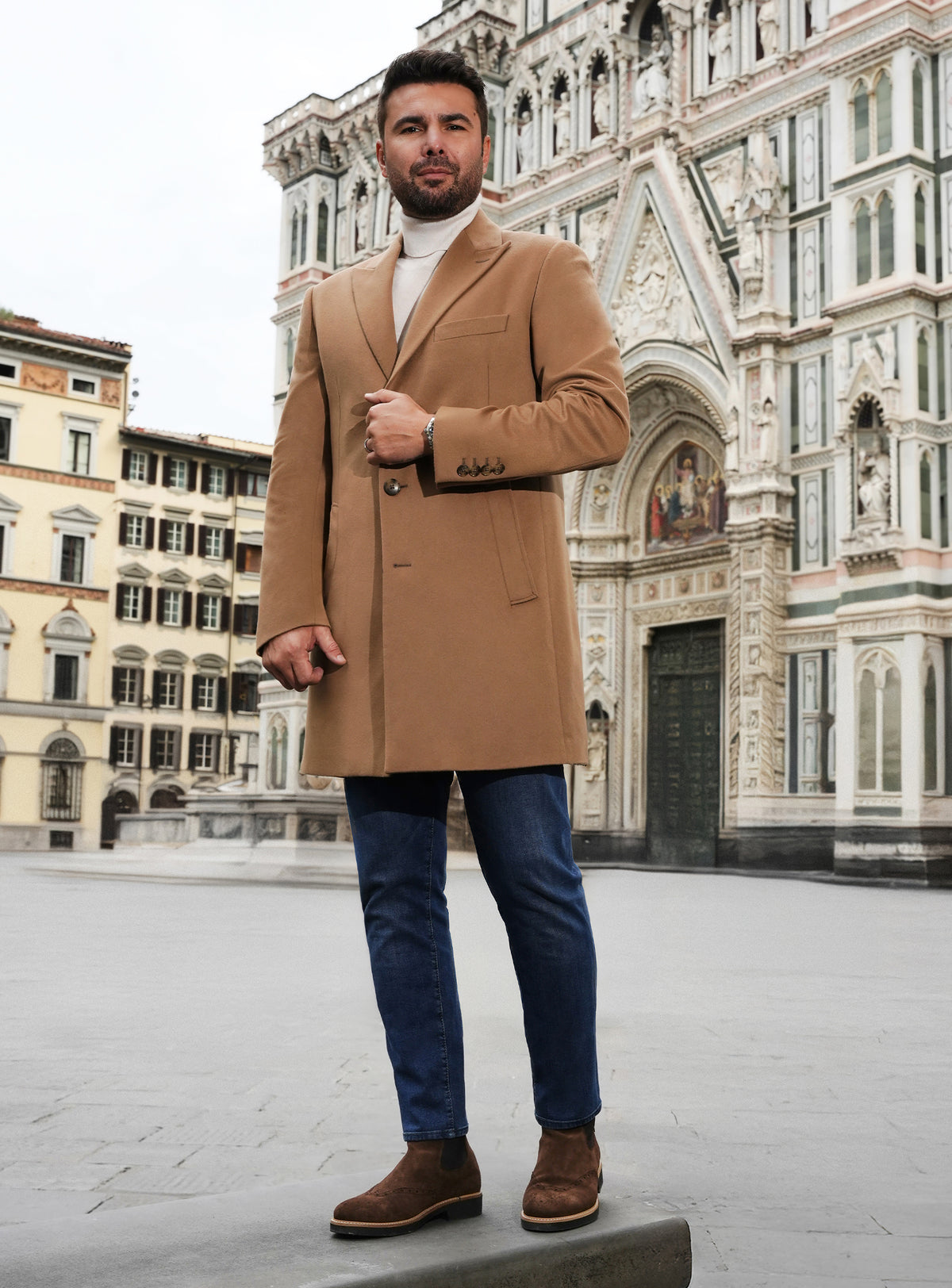 Camel Consiglieri overcoat with notch lapels, a white turtleneck and jeans