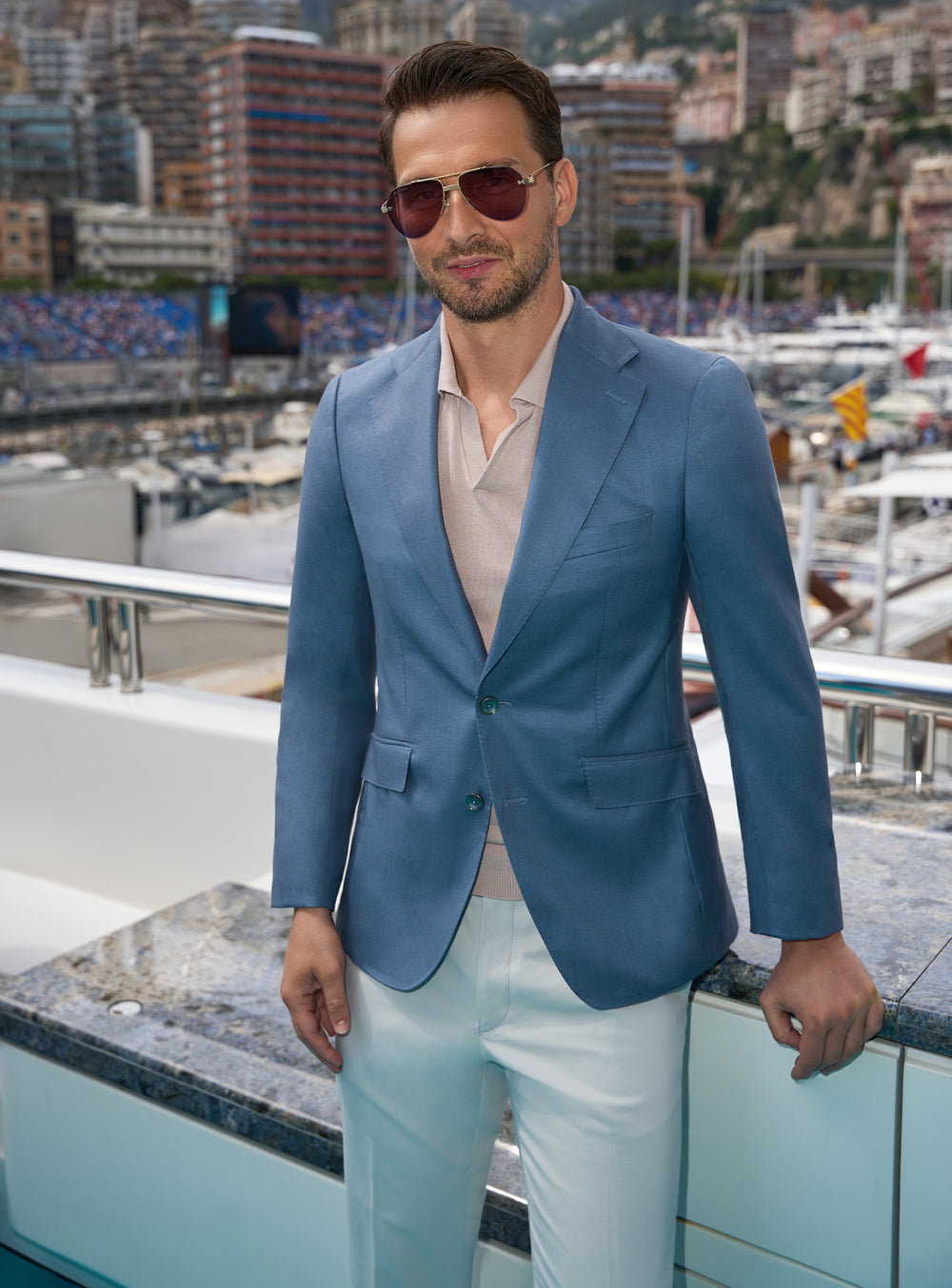 Blue Consiglieri jacket worn with a beige polo shirt and light trousers
