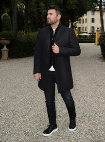 Black Consiglieri overcoat with notch lapels, styled with a black cardigan and trousers