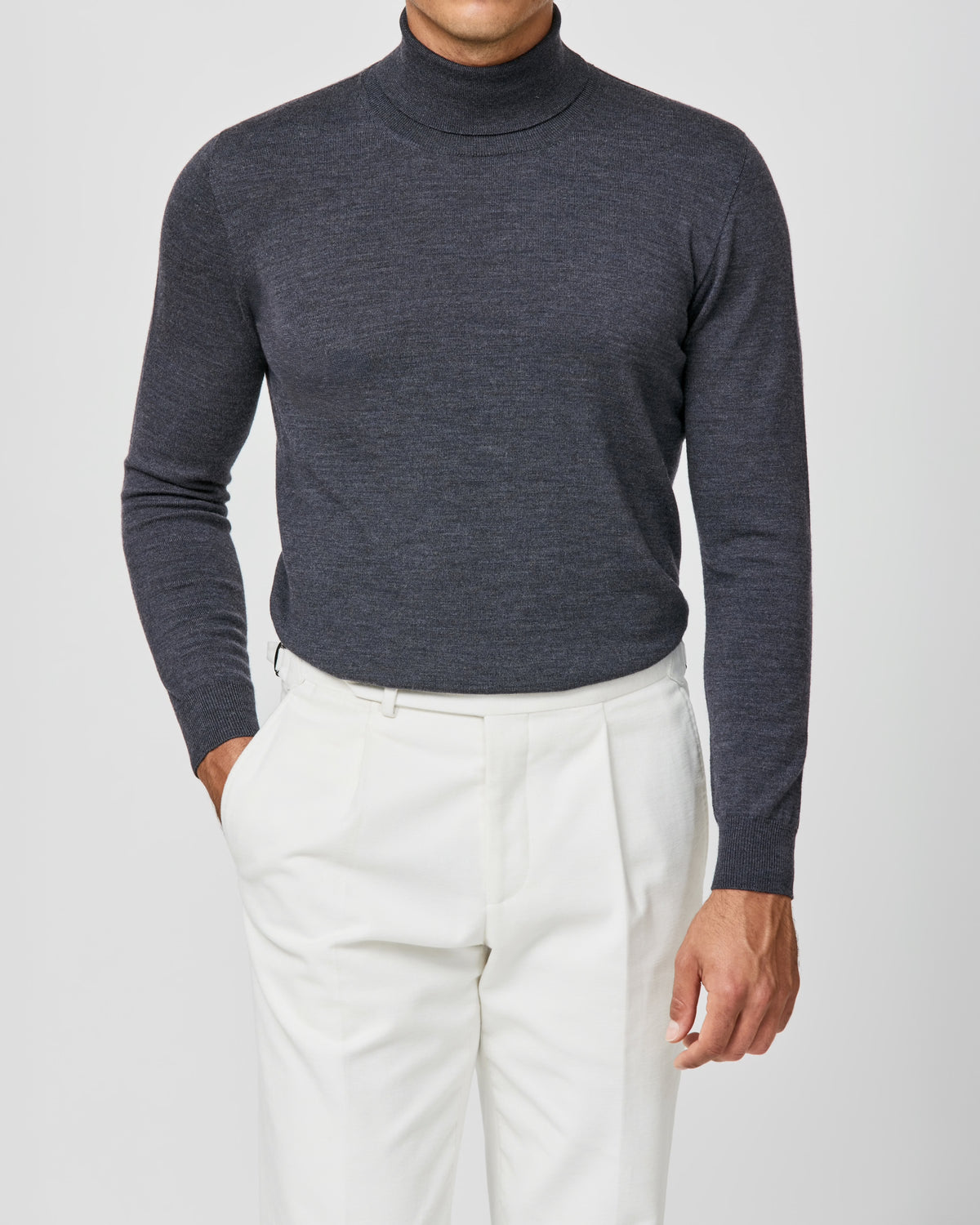 Blue-grey Consiglieri turtleneck worn with white trousers