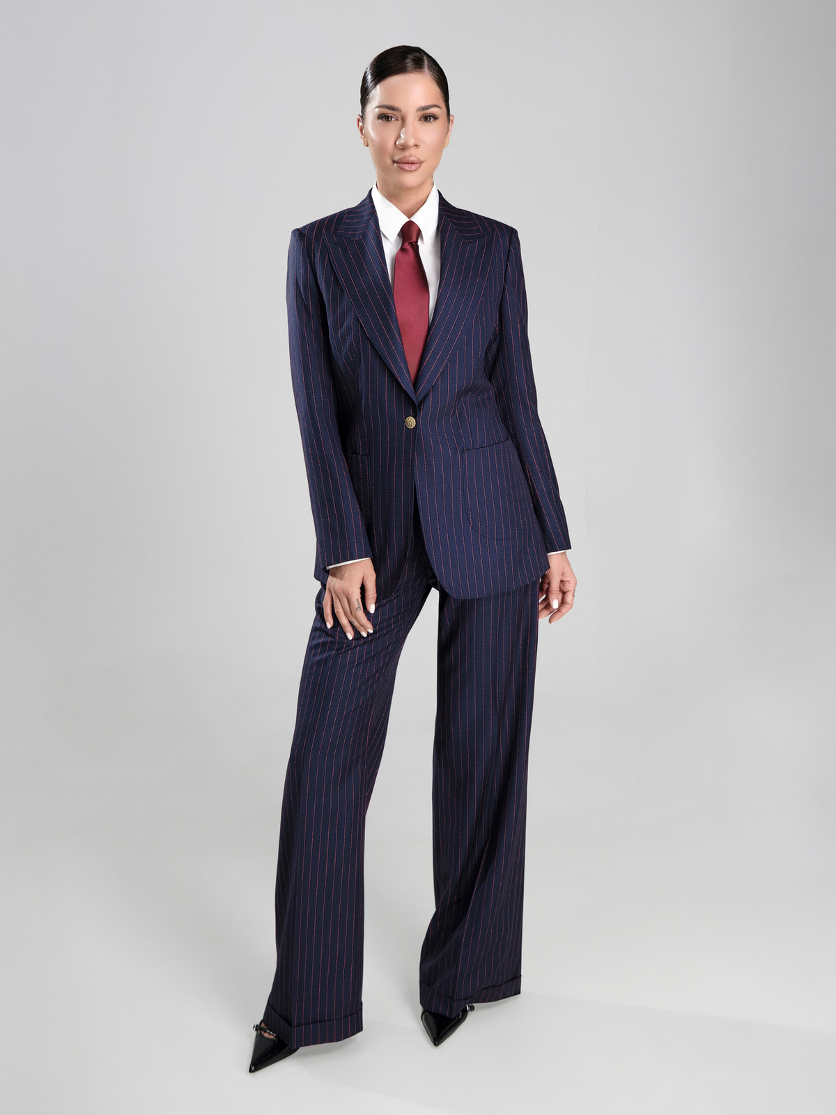 Navy pinstriped Consiglieri DONNA women's suit with a white shirt and burgundy tie