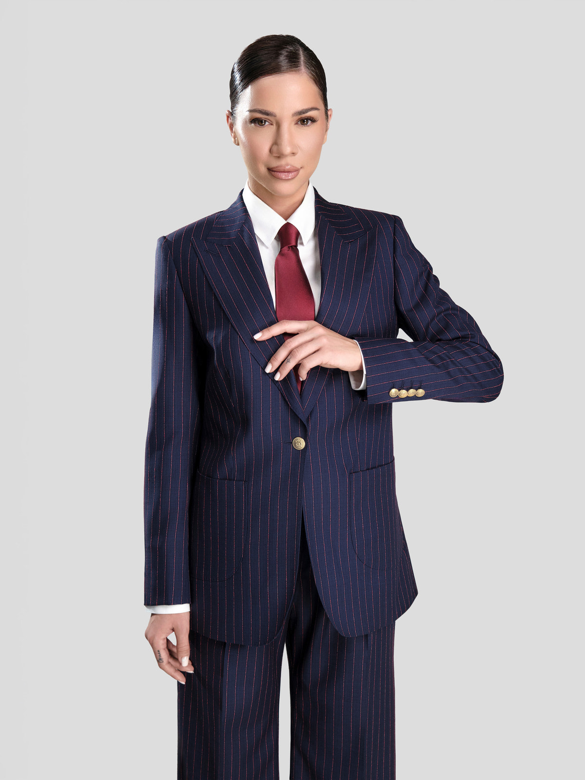 Navy pinstriped Consiglieri DONNA women's suit with a white shirt and burgundy tie