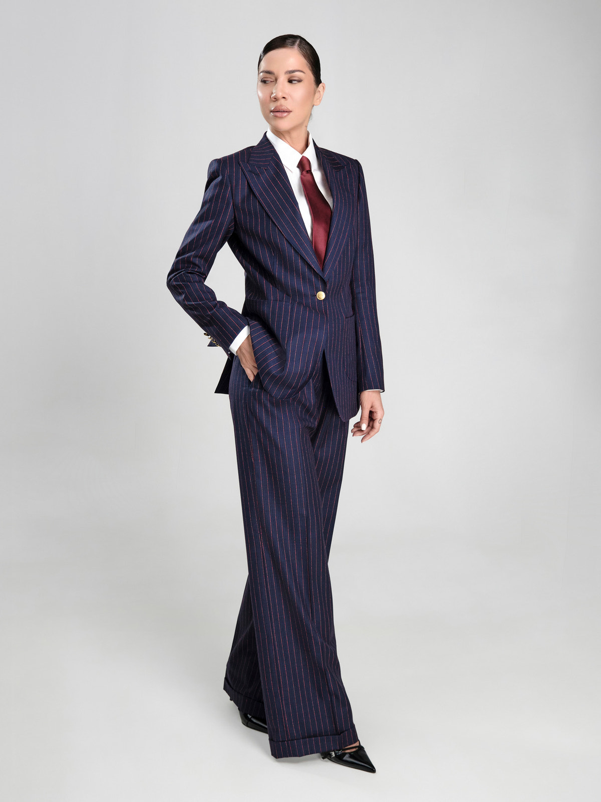 Navy pinstriped Consiglieri DONNA women's suit with a white shirt and burgundy tie