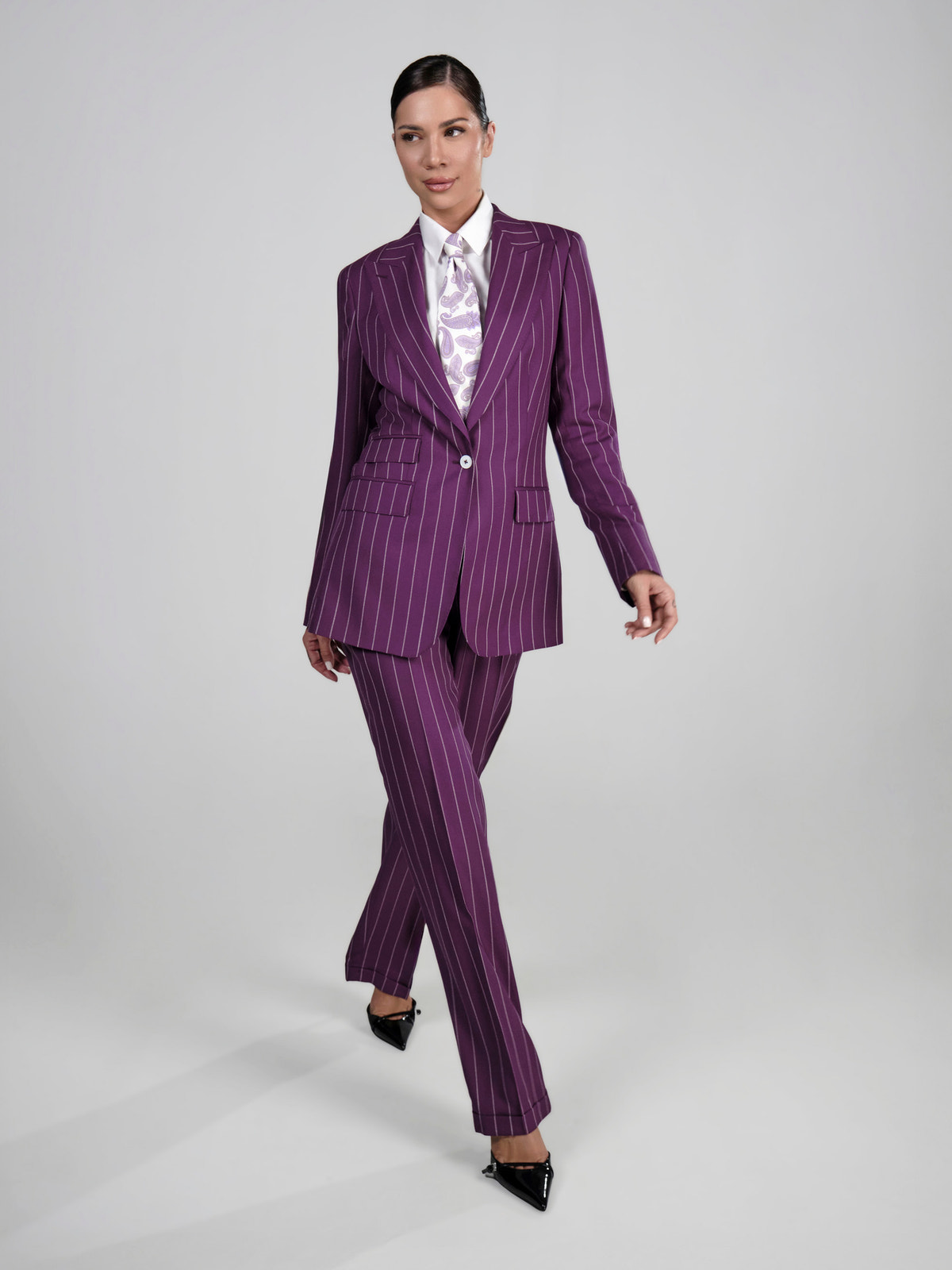 Purple pinstriped Consiglieri DONNA women's suit worn with a patterned shirt