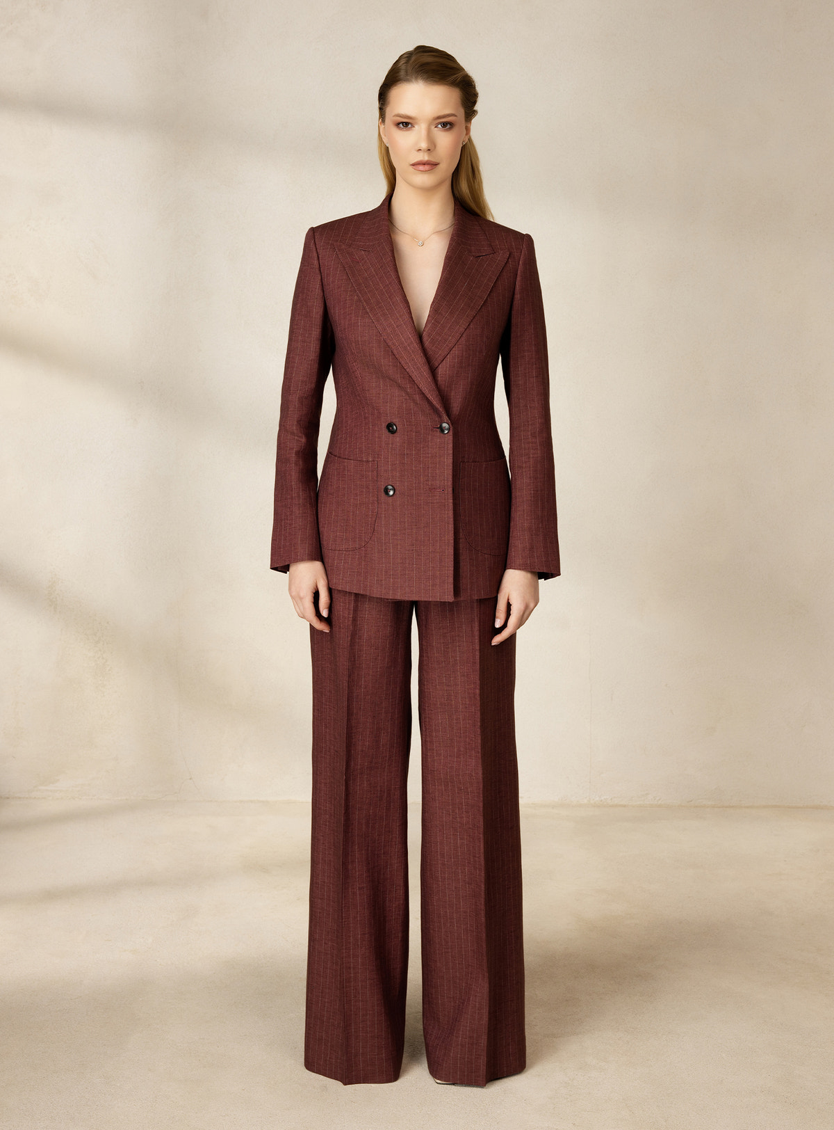 Burgundy pinstriped Consiglieri DONNA suit with a double-breasted blazer and wide-leg trousers