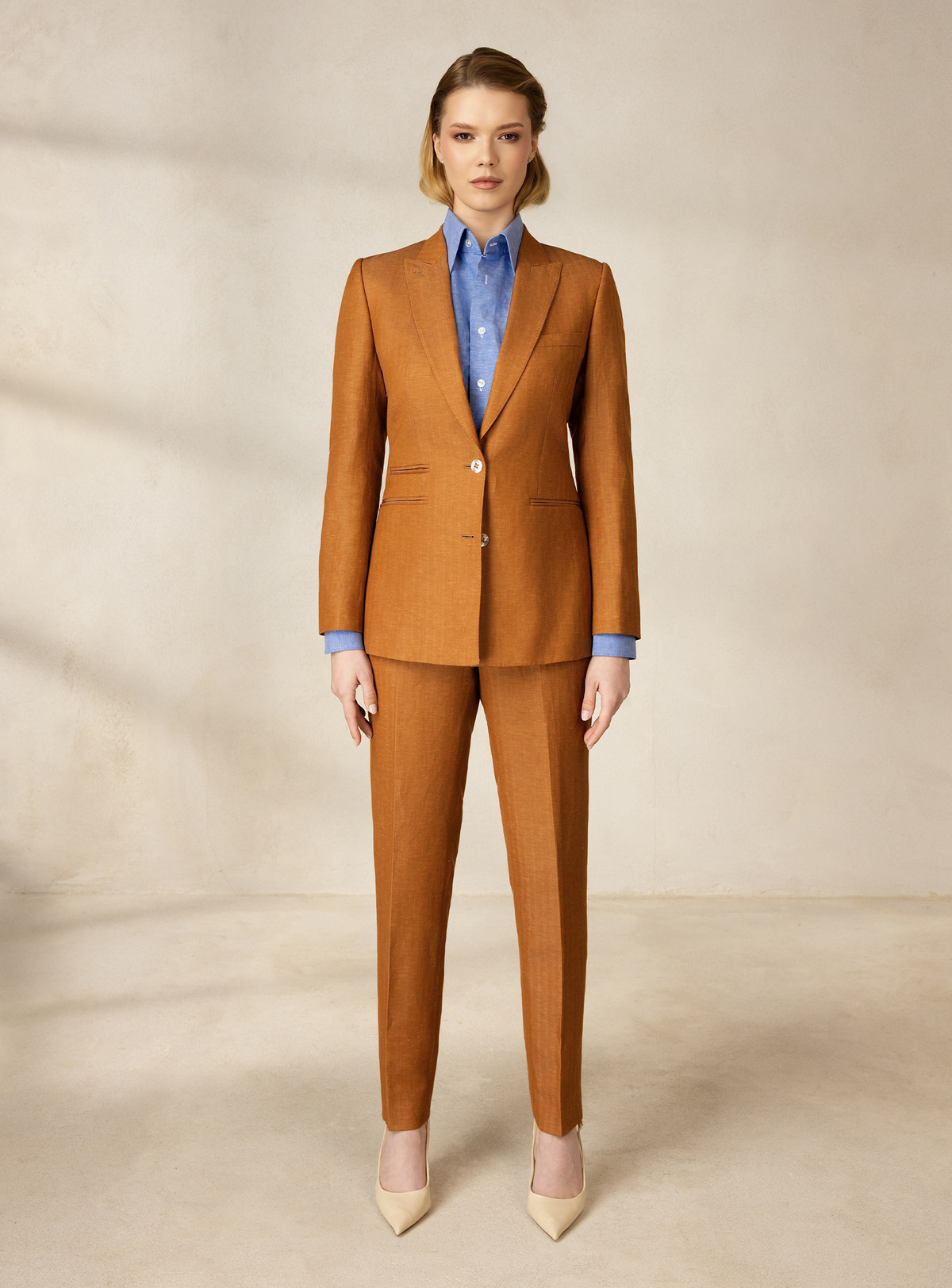 Caramel Consiglieri DONNA suit with a fitted blazer, tapered trousers and pale blue shirt