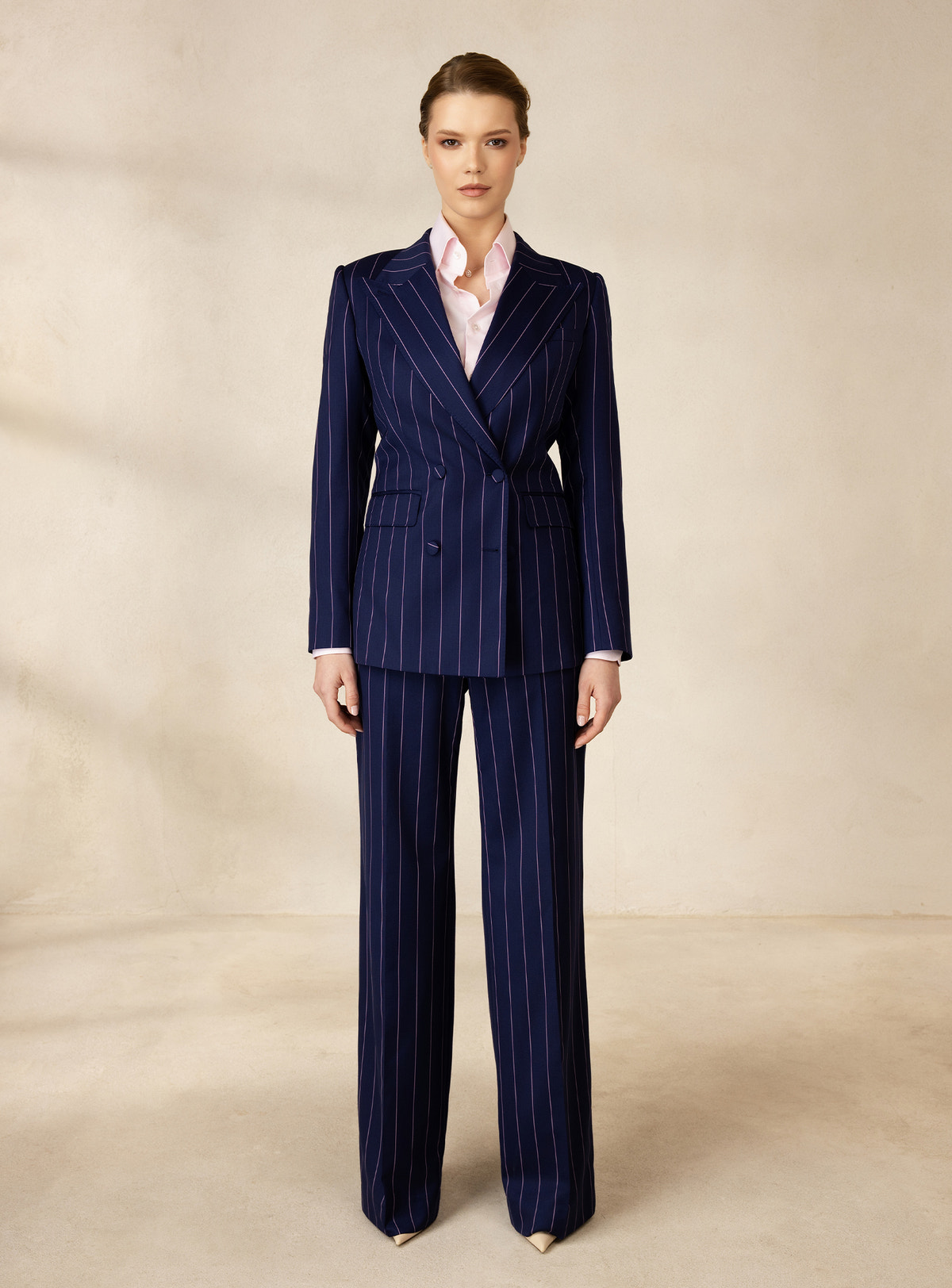 Navy pinstriped Consiglieri DONNA suit worn with a pale pink shirt