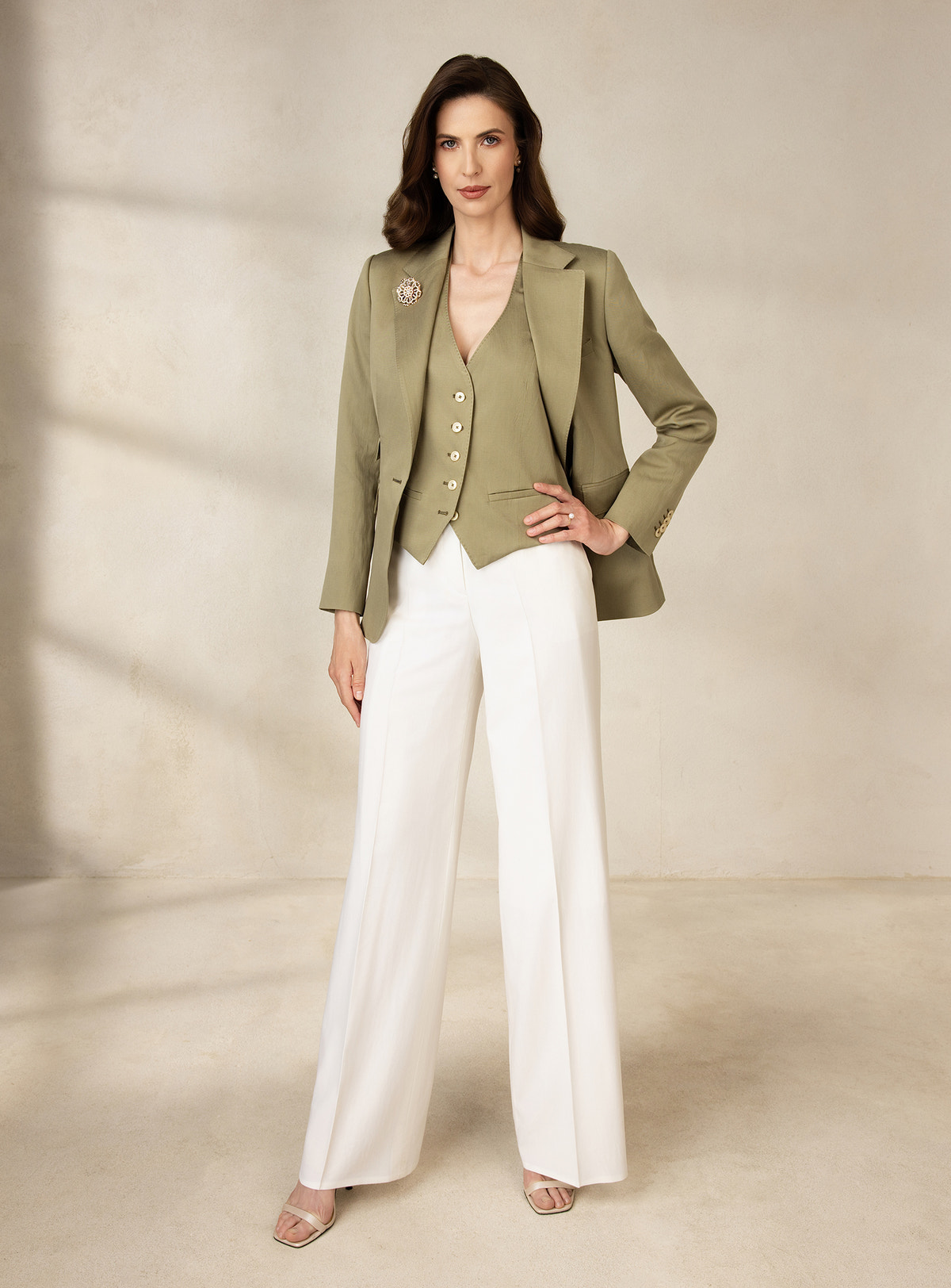 Olive green Consiglieri DONNA blazer and waistcoat worn with white wide-leg trousers