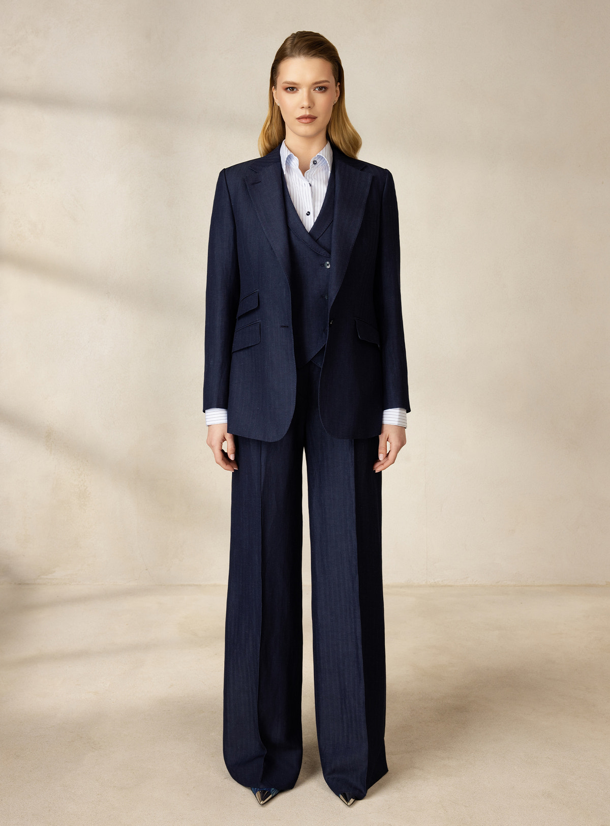 Navy three-piece Consiglieri DONNA suit worn with a white shirt