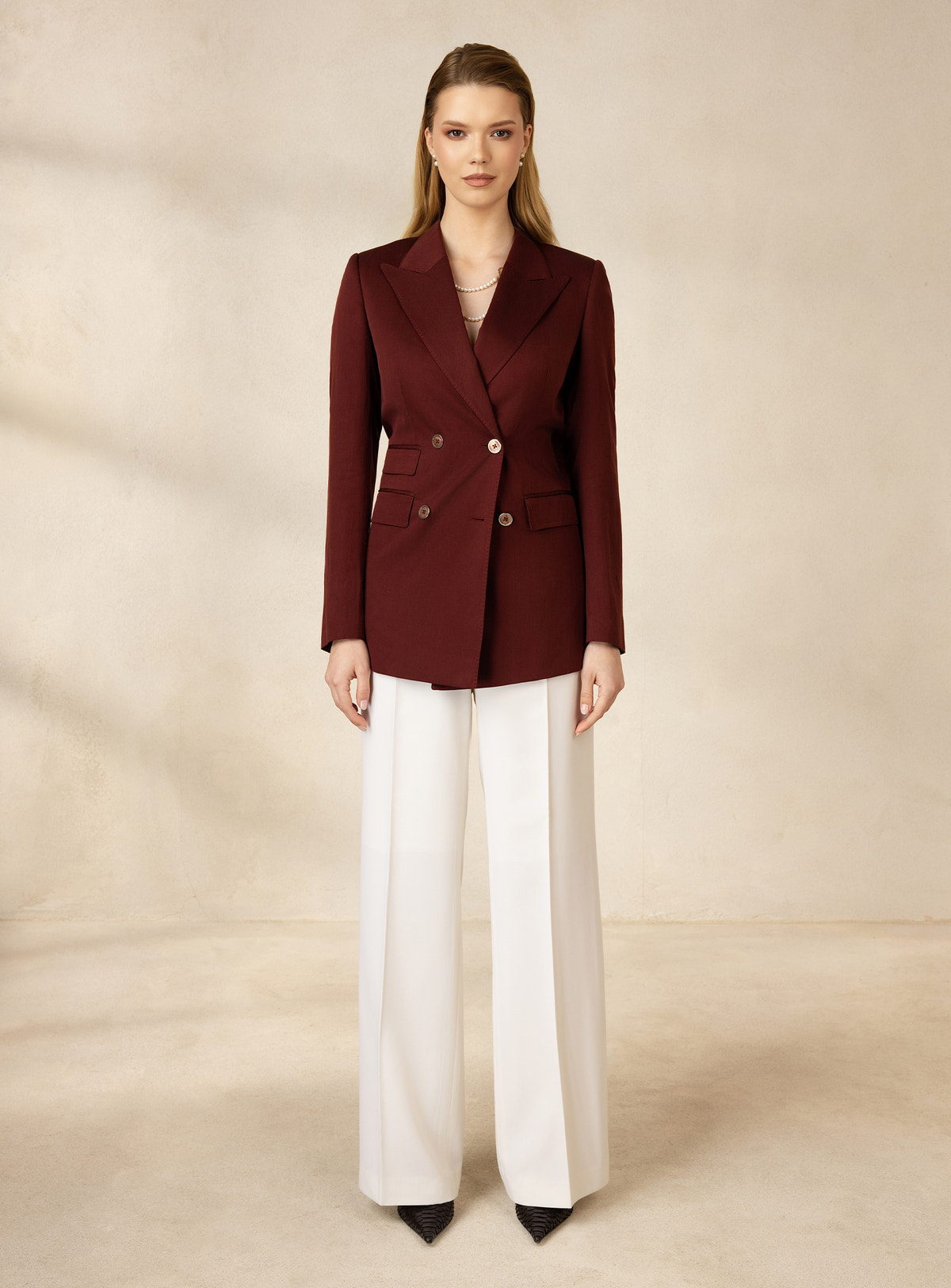 Burgundy double-breasted Consiglieri DONNA blazer worn with white wide-leg trousers
