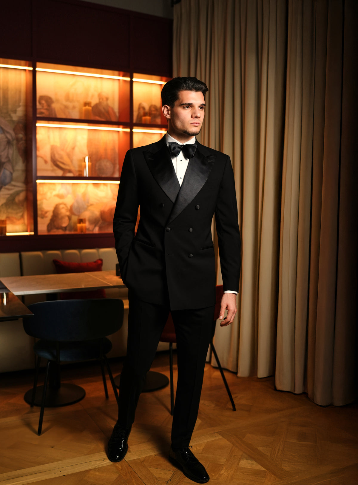 Black tuxedo and bow tie in a warmly lit lounge