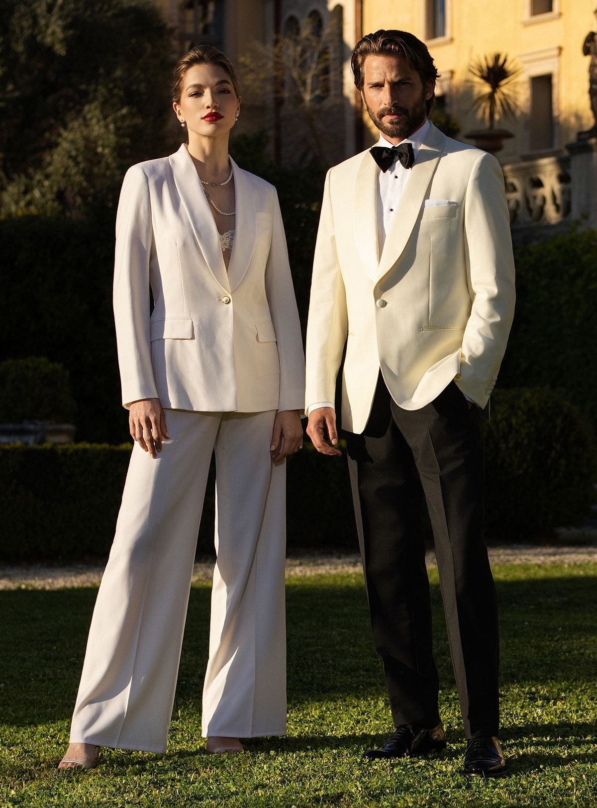 Ivory Consiglieri DONNA women's suit alongside a tuxedo with an ivory jacket and black bow tie