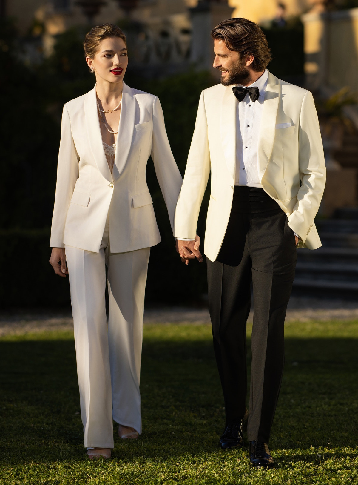Ivory Consiglieri DONNA women's suit alongside a tuxedo with an ivory jacket and black bow tie