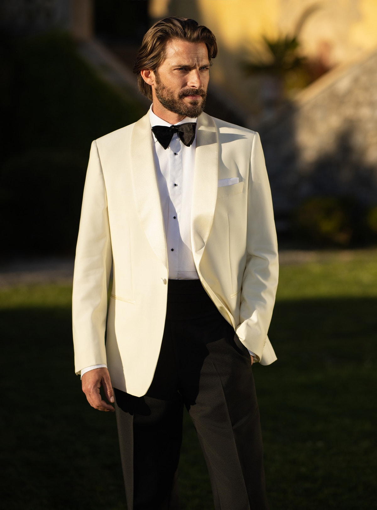 Consiglieri tuxedo with an ivory shawl-lapel jacket, black trousers and black bow tie