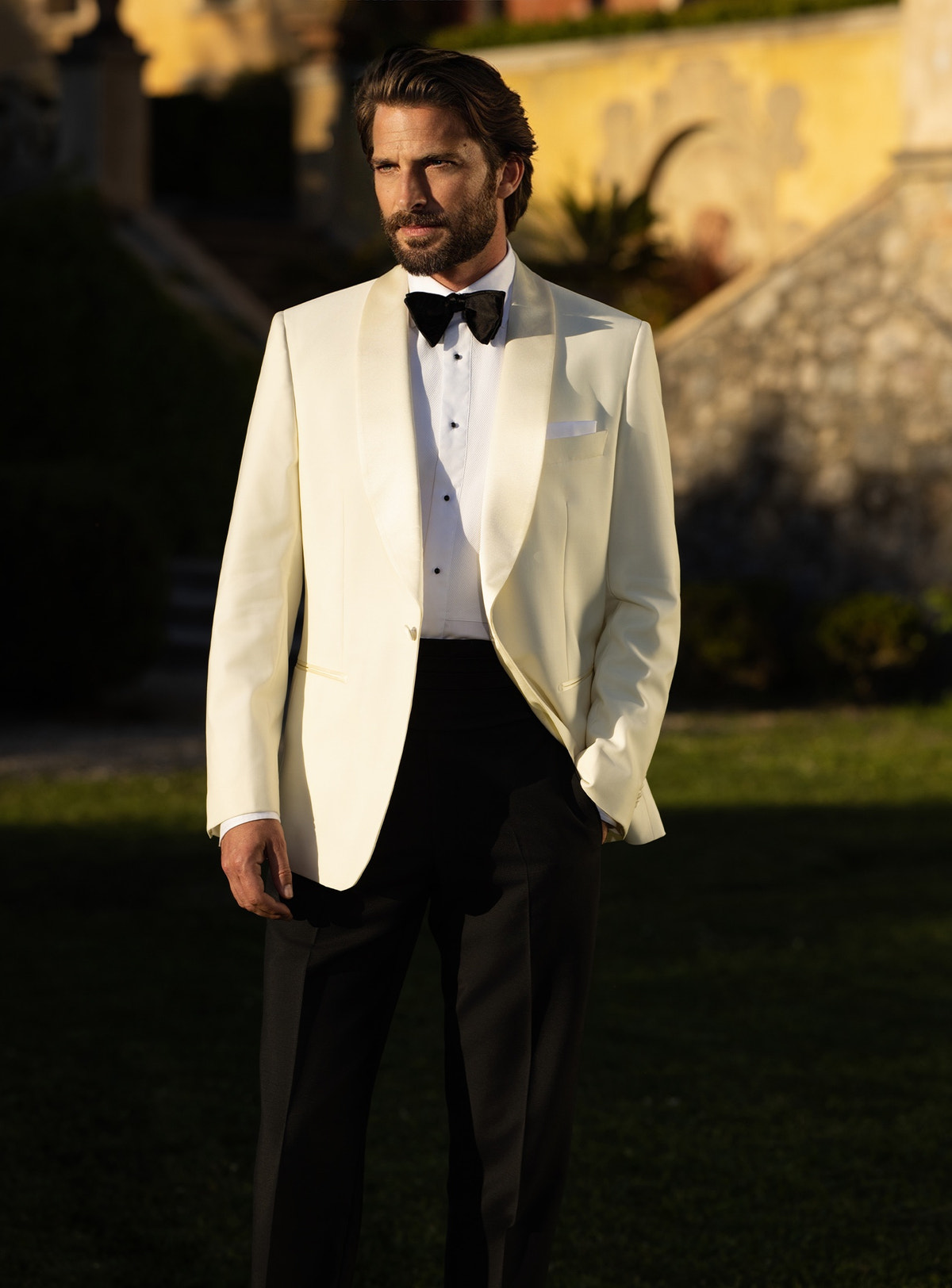 Consiglieri tuxedo with an ivory shawl-lapel jacket, black trousers and black bow tie