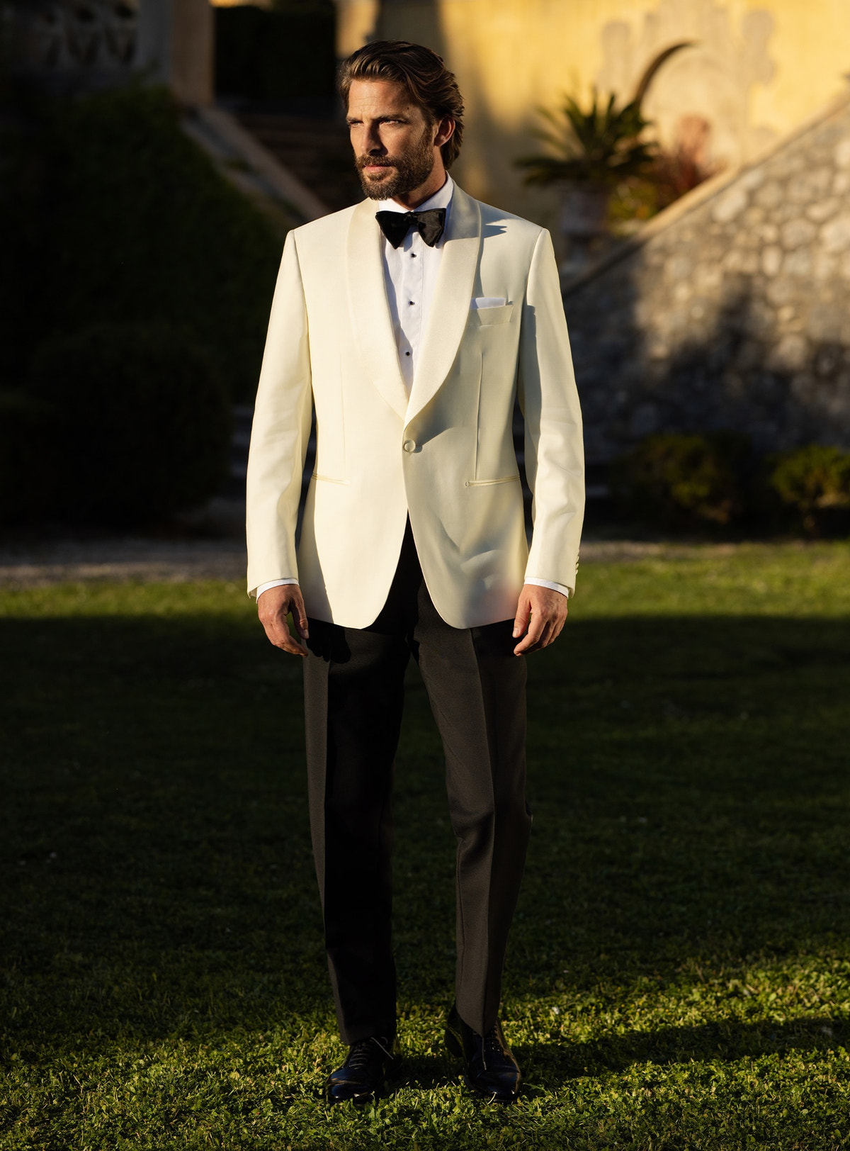 Consiglieri tuxedo with an ivory shawl-lapel jacket, black trousers and black bow tie