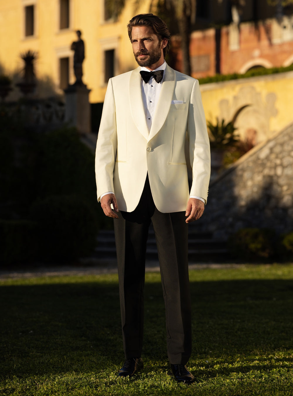 Consiglieri tuxedo with an ivory shawl-lapel jacket, black trousers and black bow tie