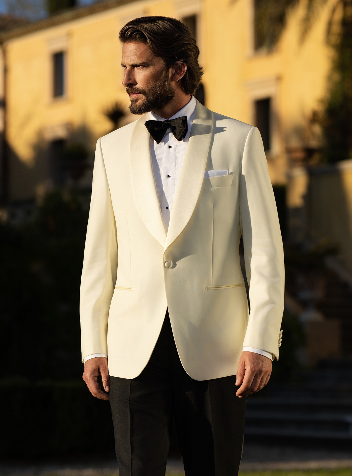 Consiglieri tuxedo with an ivory shawl-lapel jacket, black trousers and black bow tie