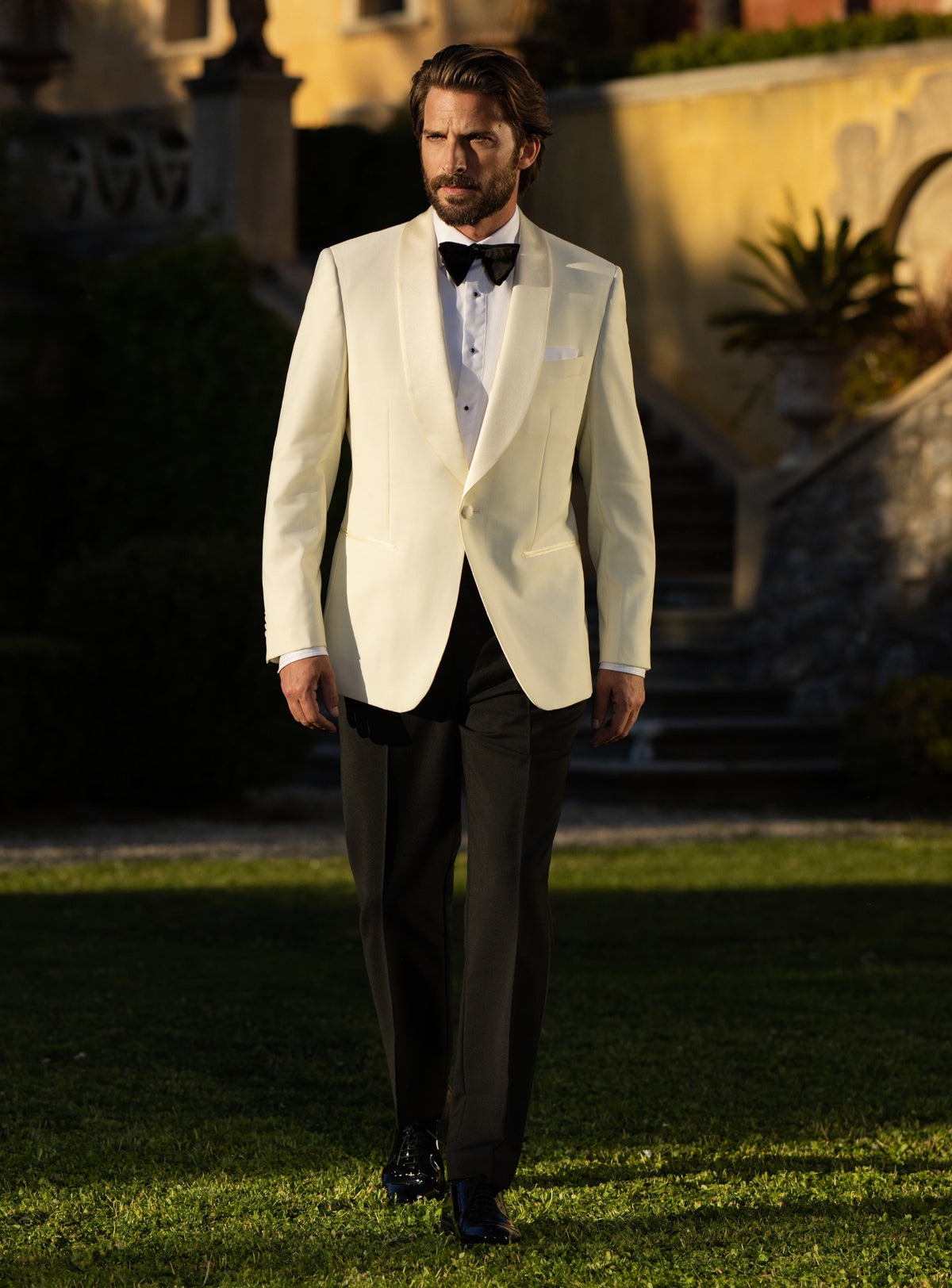 Consiglieri tuxedo with an ivory shawl-lapel jacket, black trousers and black bow tie